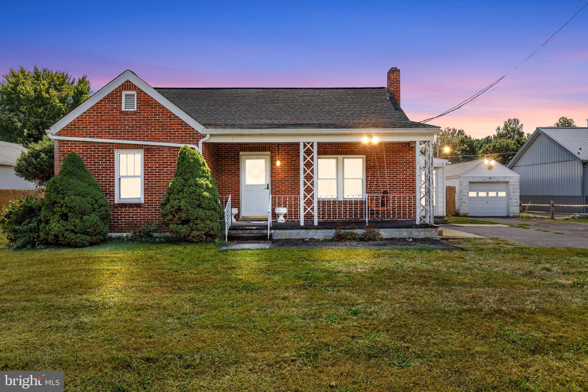 Welcome to 312 East Avenue in Greencastle! This classic all-brick Colonial offers the perfect blend of charm, space, and recent updates. Situated on a .46-acre lot with a fenced yard, this home is both functional and inviting. The main level features an open living room, dining room, and kitchen area, along with two bedrooms, a full bathroom, and convenient main-level laundry (with additional hookups in the basement). The partially finished basement includes two finished rooms currently being used as bedrooms, a partially finished half bath, and additional unfinished space ideal for storage. Upstairs, the spacious attic provides excellent storage or the potential to be finished into an additional bedroom, office, or playroom. Peace of mind comes with the many recent updates, including a new roof (2023), new central A/C unit (2022), new water heater (2024), and new water pump (2024). Outside, the property offers plenty of extras: a one-car detached garage, storage shed, and a versatile 17x25 outbuilding (currently used as a schoolroom, but perfect for a workshop or studio) with convenient alley access. The fenced yard includes playground equipment that conveys, making it a great space for children or pets. Utilities include oil forced hot air heat, cistern water source, and public sewer. Located close to shopping, dining, and just minutes from I-81 and the Maryland border. Don’t miss the opportunity to make this home yours—schedule a showing today!