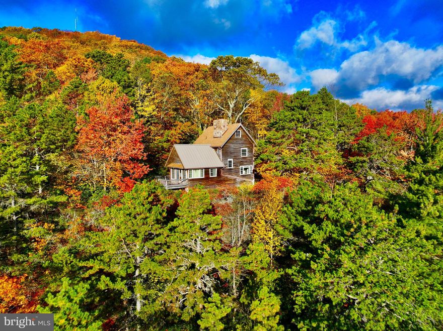 "West Virginia Mountain Paradise on 26 +/- ACRES" This 1,250 sqft, Post & Beam getaway at nearly 4,000 ft in elevation offering some of the best panoramic mountain views this state has to offer. Surrounded by more than 20,000 acres of Monongahela National Forest! This property offers ultimate seclusion & privacy but just a short graveled access off of Route 33. The private freshly graveled driveway leads to 2 newly expanded separate parking areas, fire pit, and steps down to the home. This home features gorgeous exposed beams, elevated vaulted ceiling, astounding floor to ceiling stone fireplace with a wood burning stove, 2 oversized bedrooms, 1 full bath, cherry & pine plank walls, half spiral staircase, & open floor plan. Upgraded 200 AMP electric service. Imagine waking up to the sight of the majestic Appalachian Mountains from the lofted bedrooms. Enjoy a cup of coffee from the deck as the sunrise paints the sky yellow & orange. Close your eyes, take a deep breath of fresh mountain air, inhale scents of fall, as song birds sing, and picture yourself surrounded by pristine forest as you open your eyes to mountains for as far as your eyes can see. Whether you're looking for a weekend getaway, full time residence, or hunting retreat this property is the meaning of natural beauty. Other upgrades include: new standing seam metal roof & shingled second story, insulated windows, and insulated door. Recreational opportunities in all directions including miles and miles of state stocked trout fishing water, hiking, skiing, hunting, mountain biking, whitewater rafting, and so much more all within a few miles. 8 miles to Franklin. 15 miles to Spruce Knob (WV Highest Point). 16 miles to Seneca Rocks. 30 miles to Smoke Hole Caverns & Resort. 40 miles to Canaan Valley Resort & Timberline Mountain. 50 miles to Harrisonburg, VA. 70 miles to Shenandoah National Park.