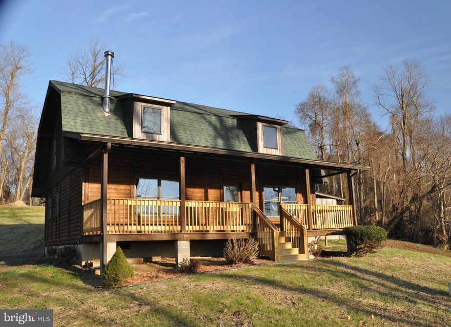 Beautifully updated & renovated log home w/ a spectacular view overlooks Allens Fresh. Kitchen's been completely remodeled w/ huge island, stainless appliances, & granite counter tops. Hardwood floors throughout. Nearly 4 AC of land has two large sheds. Enjoy gorgeous sunsets while relaxing on big front porch. Enjoy Private "Residents Only" water access, too! Truly one of a kind, come take a look.