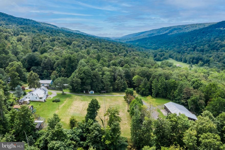 If you are looking for privacy and to get away from the hustle and bustle of the city...
This 5.3 acre parcel of land sits right in the valley and offers mountain views in every direction.  This home and land have seen many changes from being a sawmill, farmette, beauty parlor, and has the potential for even more! The home needs some TLC but the whole property is limited to only what you can envision!
The detached 2 bay garage contains a lift to work on your vehicles or do some hobby restorations.  Come take a look at this lovely and peaceful property.  This home is being sold 'AS IS, WHERE IS'.