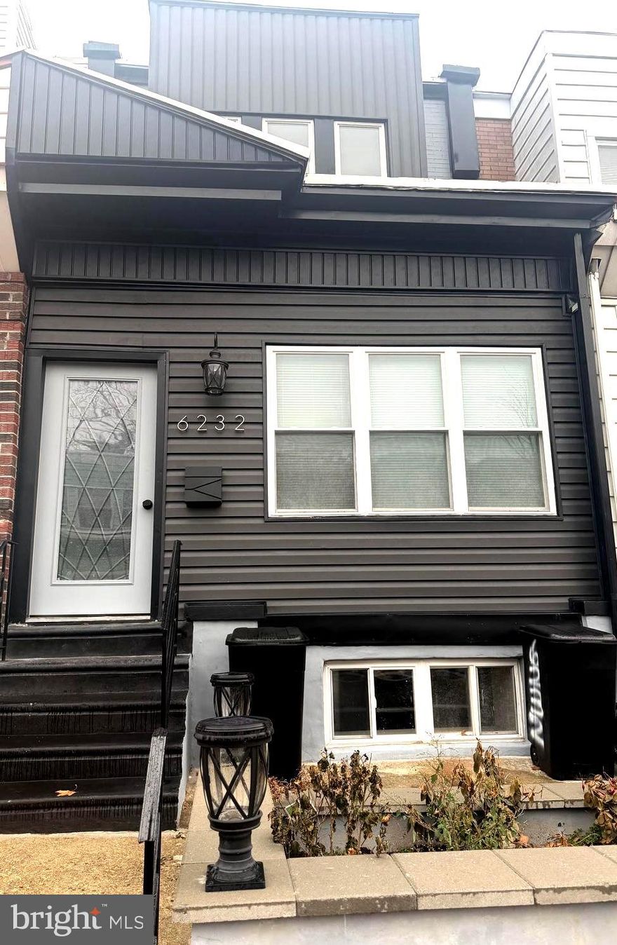 Welcome to 6232 Larchwood Street, a beautifully renovated home located in the heart of Cobbs Creek, Philadelphia. This inviting residence features elegant marble tile flooring from the enclosed porch through the open-concept living space, leading into a stunning kitchen with white cabinetry, gold hardware, and designer lighting. Just beyond the kitchen, a newly built deck offers the perfect setting for summer barbecues, celebrations, or relaxing at sunset.

Upstairs, the home offers three spacious bedrooms with stylish wood laminate flooring throughout. The primary suite includes sliding closet doors and a spa-like bath with a floor-to-ceiling tiled shower, while smart toilets in every bathroom add modern convenience. A fully finished basement provides washer/dryer hookups and additional storage, completing this move-in-ready home designed to impress today’s buyer.