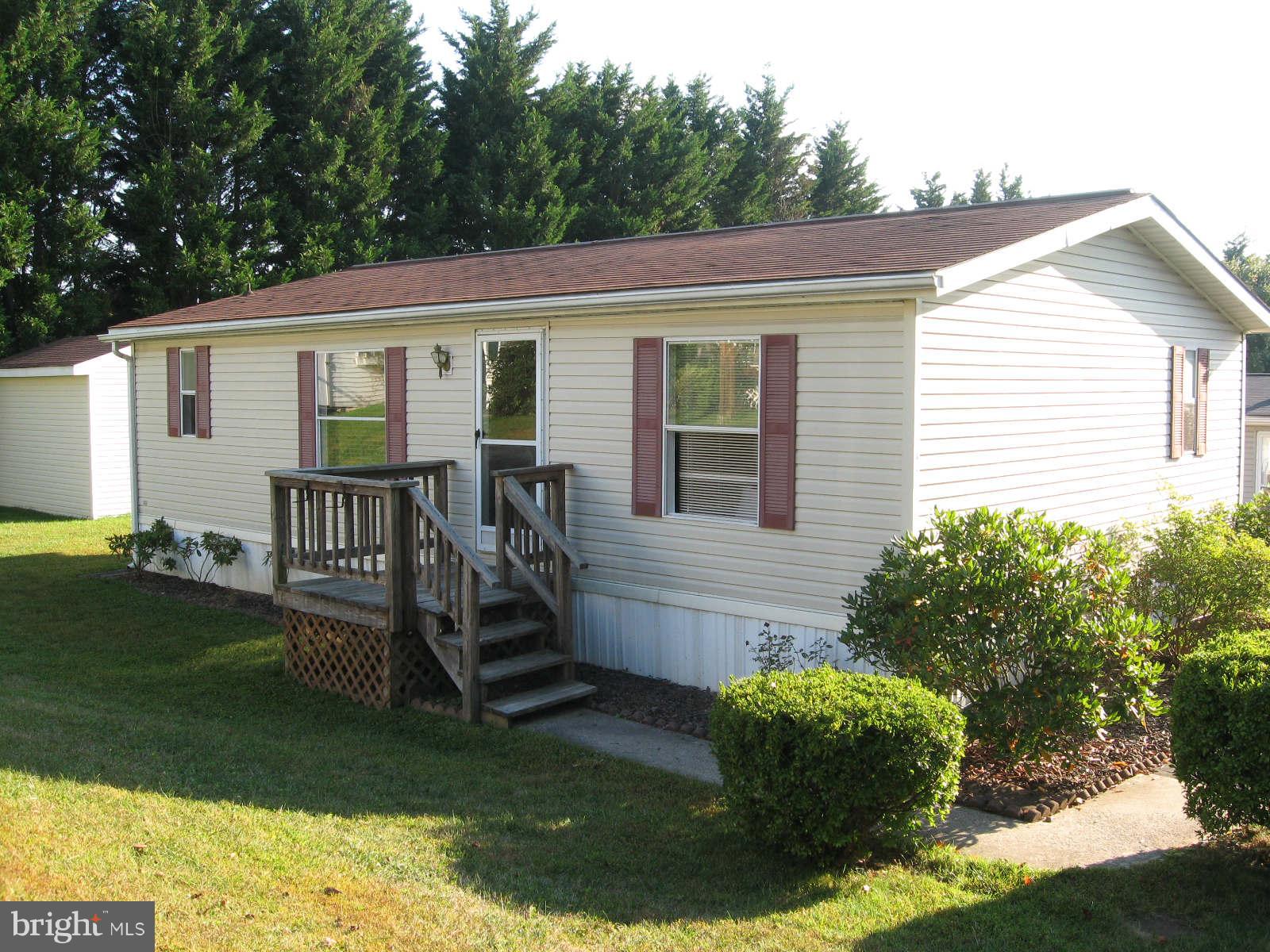 The parks "doll house". It looks small outside but will surprise you when you step inside. Living room & kitchen are open with laminate flooring & vaulted ceiling gives a sense of openness.2 nice size BR's,2 full baths. Roof is approximately 3 years old. Large storage shed & oversize parking pad.$582 ground rent includes water, sewer, taxes,trash & snow removal.Park manager must approve buyer.