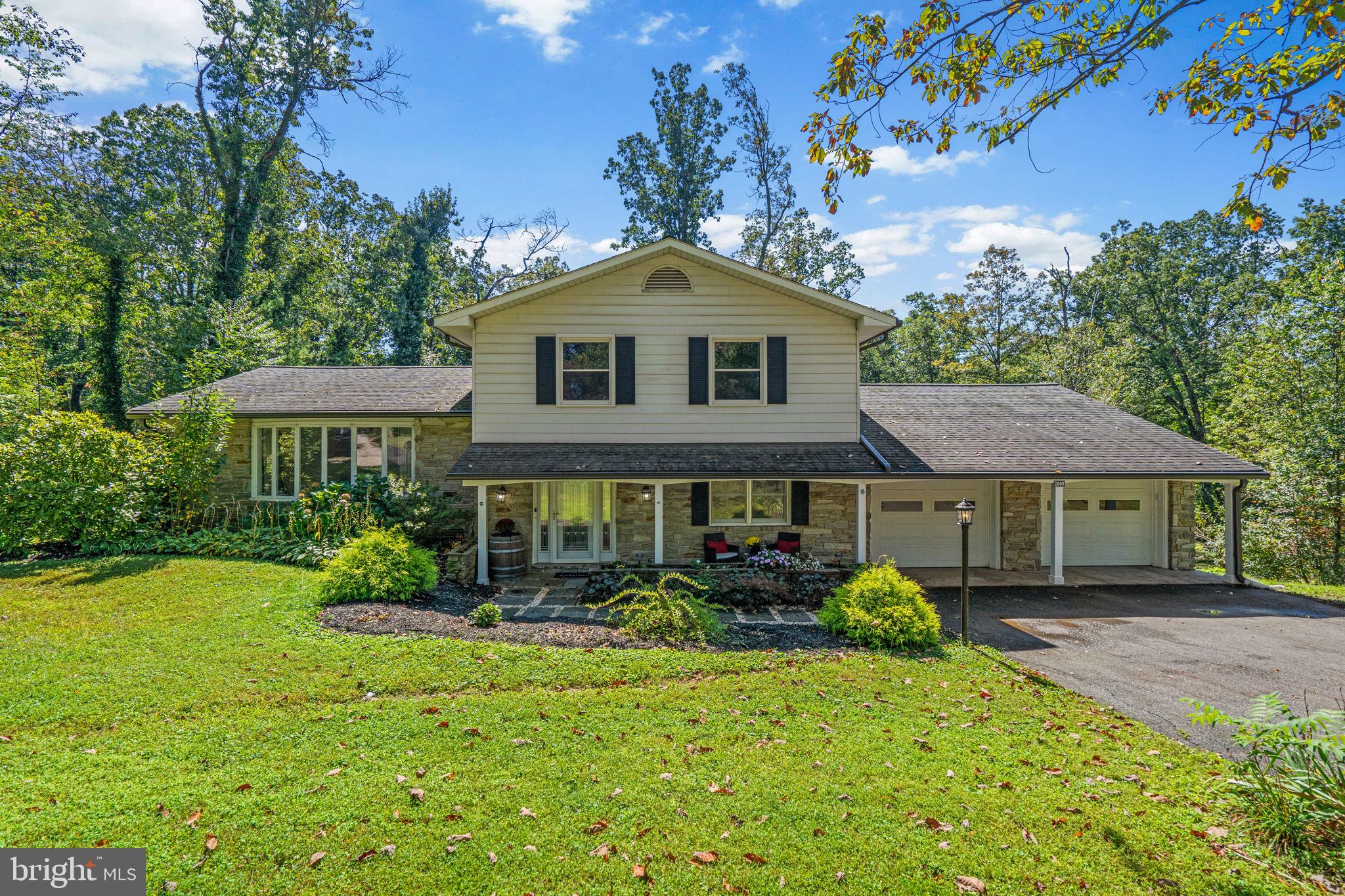 Welcome to this beautiful 4-bedroom, 2.5-bathroom split-level home nestled in a semi-private setting in desirable Mt. Airy, MD. Surrounded by mature trees and lush greenery, this property offers the perfect blend of peaceful seclusion and convenient living. With 2,208 square feet of thoughtfully designed living space, this home boasts a warm and inviting layout ideal for both entertaining and everyday life. Highlighting the home is gorgeous, on-trend hardwood flooring, as well as oversized windows that invite nautral light throughout the space. As you step inside, a welcoming foyer opens into a spacious family room, complete with a cozy pellet stove perfect for crisp fall or winter evenings. For convenient living, a bedroom or home office, a half bath, and laundry also exist on the main level. Only a few steps up bring you to the heart of the home—the kitchen. With ample cabinetry, high-end granite countertops, a bay window, and a separate dining area, the large kitchen is as inviting as it is functional. A casual living area with built-in cabinets and oversized windows creates a bright and airy space to welcome and entertain guests. Just a few steps up from there, you’ll find three spacious bedrooms, including a primary bedroom with a full ensuite boasting a double-sink vanity, high-end granite countertops, and plenty of cabinetry. An additional full bathroom with tub/shower rounds out the upper level. If nature and the outdoors is what you seek, step out back to your expansive deck overlooking a sizeable back yard with fire pit area and a shed. Equally appealing, the front porch is a perfect spot to enjoy morning coffee while taking in the tranquil, wooded surroundings. The front and back yards offer an abundance of space for play, gardening, or simply relaxing in nature. Bonus- the oversized two-car garage provides plenty of extra storage space. Located minutes from local shops, dining, and commuter routes, yet tucked away for a sense of escape — this home offers the best of both worlds. Don't miss your chance to own this Mt. Airy gem!