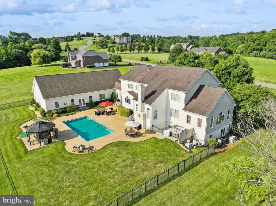 *** OPEN HOUSE SAT JUNE 15 - 1230-330 PM *** PICTURES WILL BE LOADED ON JUNE 14*** Situated just west of Historic Leesburg in the gentle rolling hills is a stunning 9000+ sqft multi-generational home. It features a primary residence of over 6500 ft on three levels with a three-car side load garage.  But what takes this property from outstanding to exceptional is the semi-detached completely independent living In-Law Suite. The 2500+ sqft addition was masterfully integrated by a Local Builder/Architect who has seamlessly brought the properties together with thoughtful and clever architecture. The two separate residences are connected by a 30-foot climate-controlled breezeway.  The In-Law suite can accommodate any living domicile need it is entirely main level living without a single stair or step needed to gain access from the driveway or 2-car garage.  This part of the property has a 25-foot soaring cathedral ceiling with decorative accent timbers placed on the whole length.  The residence has a main level primary suite with full bath, gourmet kitchen, family room and dining room.  In addition, a well-designed loft area offers multi-functionality that can be used as a home office, guest stay area and features a separate second full bath. The In-Law Suite also has direct access to the pool and outdoor entertainment area.  Enjoy the picturesque, serene views from your in-ground heated pool with a southern exposure. The Primary Residence’s grand semi-circular staircase greets the Homeowner the main entrance with a 2-story foyer with an elegant Dining Room and Living Room  combination.  Walking through to the Living Room brings one to a very large versatile Sunroom. The main level is completed with a Updated Kitchen, Home Office/Study and Family Room combination with 2 story vaulted ceiling and wood burning fireplace.  With multiple access points grants the Homeowners can enjoy the serene & private fabulous pool and entertaining area with multiple loungers areas, built-in grill and 4 golf holes for practicing your short game.  The upper level of the Primary Residence has 4 bedrooms & 3 full baths. The Primary Suite is very inviting with a sitting area, updated bath and a massive closet that runs most of the full length of the 3-car garage below.  The partial walkout Lower-Level grants direct access to the heated pool & deck.  This spacious Lower-Level has a bar area, pool table area, media area, fitness area and a full bathroom. Don’t wait! Be the first to take advantage of this one-of-a-kind properties to full enjoy great living while meeting the needs of any kind of living situation.