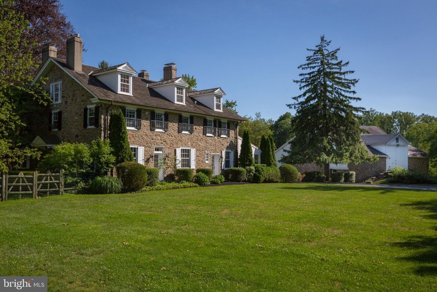 Welcome to Buttonwood Farm! A unique blend of farmhouse charm and luxury amenities, this beautiful stone home with nearly three acres of property, a guest cottage designed by Ann Ledger, and a partially finished "party barn" is a one-of-a-kind find in Easttown Township! Enter into the bright and open foyer that leads into the home's newer three-story addition. Enjoy the open concept feel of the kitchen, breakfast room and family room in this wing of the home. Notice the two-sided gas fireplace that was built with repurposed stone from the original structure. The gourmet kitchen features stainless steel Viking appliances including a six-burner gas range and double oven. French doors lead from the family room to the patio and saltwater swimming pool. Down the hall past the convenient main floor laundry room, butler's pantry and powder room you will enter the original structure of the home. The living room features a French door leading to the patio and an over-sized gas fireplace that was once the kitchen hearth. Two additional fireplaces are located at either end of the formal dining room, one of which is flanked by built-in cabinetry. A warm and inviting den with another gas fireplace and pocket doors completes the main floor. On the second floor you will find the master suite with a luxurious en suite bathroom featuring a jetted tub and walk-in steam shower, three additional bedrooms, and a hall bathroom. Two of the additional bedrooms have decorative fireplaces. The third floor is ideal as a teen haven with two bedrooms, a full bathroom, and a hang-out space. The finished lower level, which is part of the newer addition, is a great space for entertaining. There is a media room, recreation room with built-in wet bar and kegerator, and a wine cellar that can hold up to 2,500 bottles. The delightful guest cottage was designed by local architect Ann Ledger. It features a living room with a gas fireplace, a full kitchen with stainless steel appliances, a guest suite with an en suite bathroom. Finally, the unique "party barn" is what truly sets this home apart. A two-story great room is the focal point of this space with room for any size gathering. The barn also has two versatile rooms that are currently used as a home office and an exercise room. Enjoy the peaceful surroundings, yet still have easy access to shopping and dining in Newtown Square and Wayne, nearby golf clubs, regional rail, and Amtrak service. Don't miss this incredible opportunity!