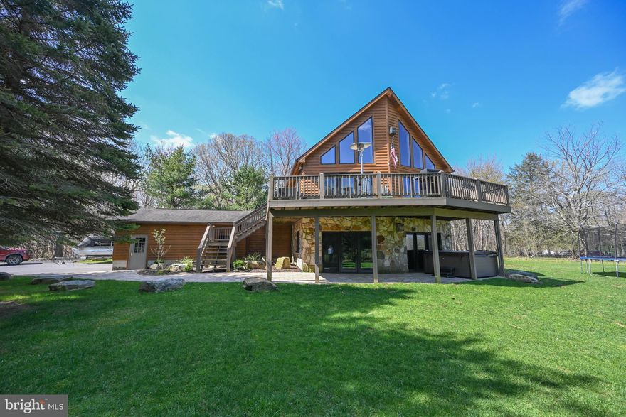 This stunning chalet sits mountaintop overlooking the heart of Deep Creek Lake. This spacious home has 4 bedrooms, three levels of living space, an attached 2 car garage, and sits on a pristine, level lot. Checks every box imaginable in a dreamy getaway property! There have been many upgrades throughout and tons of endless memories made over the years. This house is situated in a very ideal location close to all area amenities such as the lake, Wisp Ski Resort, ASCI Whitewater course, all local restaurants, shopping, etc; yet has privacy within it's own parameters. Best of both worlds! Schedule your showing today to see this spectacular place!