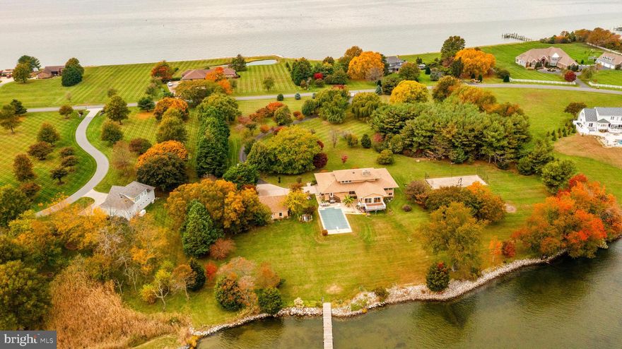 Welcome to 3013 Bennet Point, a waterfront paradise nestled on the serene shores of the Wye River. This exquisite property boasts an impressive 450 feet of waterfront, offering captivating views of the Eastern Bay from the front of the house and scenic vistas of Wye Island from the rear. Privacy is paramount on this sprawling 5.4-acre estate, making it an idyllic retreat for those seeking tranquility and natural beauty.

Crafted with meticulous attention to detail and unparalleled craftsmanship, this home is the epitome of perfection. With 5 bedrooms and 5.5 bathrooms, each bedroom is a private oasis with its own ensuite bath. Spanning 5,560 square feet, this residence offers spacious living areas designed for both comfort and luxury.

Car enthusiasts will appreciate the 3-car detached garage, which is equipped to accommodate a car lift and features a vaulted ceiling on one side. Additionally, an oversized 2-car attached garage provides ample parking and storage space.

The outdoor amenities are equally impressive, including a 25x50 sport court with lights, ideal for activities like basketball and pickleball. Cool off and relax in the inviting 20x40 pool complete with a diving board. Enjoy the beauty of the outdoors from the 20x14 screened porch or venture down to the 210-foot pier with water and electric, where you can take in the waterfront views or access your watercraft with ease. Two boat lifts, one capable of handling 15,000 lbs and the other 5,000 lbs with 8ft of depth at lifts, make boating a breeze.

Entertainment is made easy with a comprehensive sound system in all shared spaces and garages, ensuring your gatherings are filled with music and ambiance. Stay connected with wired internet in all rooms, a practical feature for both work and leisure.

The heart of the home is the gourmet kitchen with custom cabinetry, all expertly crafted by an Amish artisan, and high end appliances fit for a chef. Gleaming hardwoods flow throughout the entire house, adding warmth and elegance to the living spaces. A convenient laundry room is attached to the custom mudroom, and another can be found in the master ensuite bathroom, offering utmost convenience.

Don't miss this opportunity to experience waterfront living at its finest. 3013 Bennet Point is a testament to luxury, comfort, and unmatched craftsmanship. Schedule your viewing today and make this remarkable estate your own.