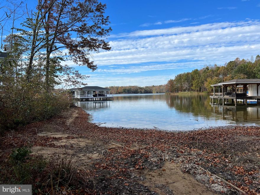 Waterfront lot in one of the lake's most prestigious neighborhoods,  Noah's Landing. Waterfront allows for kayaking, paddleboarding, swimming, etc. access but not the construction of a boat house (boat slips may be purchased in the common area when available). The community offers many amenities located on the private side of the lake (pool 3). It offers a boat ramp, basketball court, sandy beach, volleyball area, and covered picnic area. Being offered at below the assessment (2025 = $260,900)