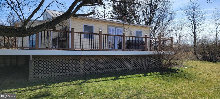 What a great find-Updated well built cottage on 1 acre with 2 amazing outbuildings..  This property has soo much potential! Live in the move in ready cottage and build your forever home on lot! Outbuildings have business potential-imagination is all that is needed. Beautiful views to the west off the huge deck. Freshly painted with new LVT flooring, this charmer is move in ready. New windows. New heat pump.   30 x40 workshop with 1/2 bath, heated office and 10' ceilings, large garage door, separate 200a electric, TV and internet lines connected.  Large area for gardening, coy pond,  Second out building was used as art studio, storage is below. Public sewer and water.  House is in good condition, and is offered as-is.