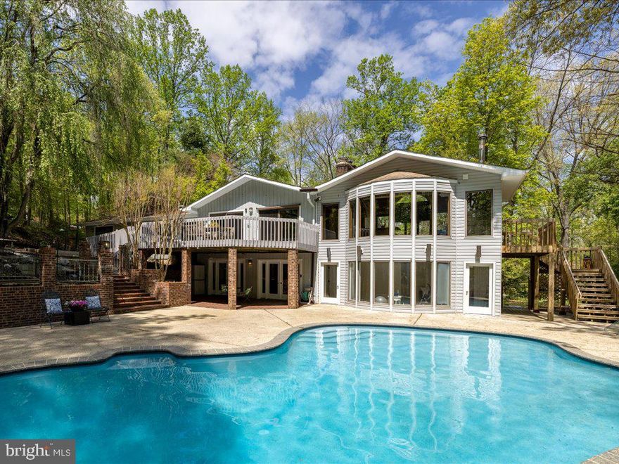 Open House Sunday, 4/28, 2-4P. Welcome to this exquisite ranch-style oasis, where luxury meets comfort at every turn. As you step inside, you're greeted by a sense of warmth from the beautiful hardwood floors that are throughout the main level.
The heart of the home, the kitchen, is a chef’s delight. Featuring granite counters, a Viking six-burner gas stove, stainless steel appliances, great table space, and its own wood-burning fireplace, perfect for casual dining or hosting lavish gatherings. The adjacent sunroom is a true haven, with its wood-burning stove, built-in bar, high ceilings, and walls of windows that frame breathtaking views of the pool and spacious backyard. An inviting deck off the back is ideal for outdoor dining and barbequing on this 2-acre estate. 
Entertaining is effortless with the seamless flow from the kitchen to the dining area and living room adorned with a gas fireplace and picturesque windows that bathe the rooms in natural light providing captivating vistas of the lush outdoors. The main level is designed for convenience and relaxation with the primary bedroom nestled away on the right wing of the house.  This lovely room features a private deck perfect for morning coffee, a fireplace, and a newly renovated ensuite spa bath. The main level also offers three additional generous bedrooms, along with a spacious laundry room.  The attached two-car garage provides easy access to the home, with the added bonus of an electric car charging station for eco-friendly living.
Descending to the lower level, you'll discover a haven for comfort and enjoyment. New luxury vinyl plank flooring sets the stage for a spacious family room, complete with a fourth fireplace, perfect for cozy gatherings or movie nights. A separate playroom provides ample space for little ones to play and explore, while a fifth bedroom and full bathroom offer comfort and privacy for guests or family members. 
For those seeking a private retreat, an adjoining studio awaits, complete with its own full bath, ideal for use as a home office, art endeavors, or fitness room.
Step outside to discover a paradise for outdoor living and entertainment where the pool beckons on warm summer days.  Enjoy the spacious patio, outdoor firepit, nearby sports court and gardening boxes already set. Just down the street, take advantage of all the incredible amenities that Harbor Hills has to offer such as the community clubhouse where the neighborhood holds Friday Night barbeques throughout the summer months, an Olympic-sized swimming pool, tennis courts, marina, beach, playground and ballfields. Set around the waters of the South River and just minutes to Annapolis, DC and Baltimore, there is so much to love, which makes Harbor Hills one of the most desirable Communities in Anne Arundel County.

Please don't forget to see the multitude of amenities in Harbor Hills! Pool, pier, and tennis located at 1 Carson Cove, Ball Field Location: Drive-in on Constellation Dr. Walk-in entry at Godspeed Drive,  Beach Area Location: Gated entry at end of Constellation, Merrimac Waterfront Location: Near the end of Merrimac Road, on the right