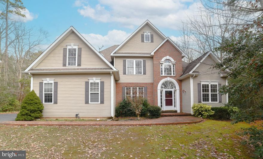 A little TLC for a whole lot to LOVE! This spacious St. James Colonial offers more than 3,100 square feet of gracious living. Palladian windows and hardwood floors add elegance to the formal 2-story foyer.  The living room/study and formal dining room lead back to an open family room and eat-in kitchen. In the family room, a soaring, vaulted ceiling opens to the loft space above and the propane fireplace provides warmth and ambiance. The spacious eat-in kitchen features tall Maple cabinets, pantry closet and a big island w/wine fridge, great for gatherings. 1st floor primary ensuite with tray ceiling and walk-in closet makes one-level living easy. Upstairs are three more good-size bedrooms, two with walk-in closets. The loft makes a great computer or reading nook. Enjoy the wooded view and weather in the enclosed back porch/3-season room or head outside to the back patio. The 2.44-acre yard is deep and provides privacy and room to play! A convenient mud room is off the 2-car, side load garage. When things heat up back up, swim at the community pool! Close to PAX and opposite heavy traffic on 235.  Don't miss your opportunity to give this gem some love, request your showing today!