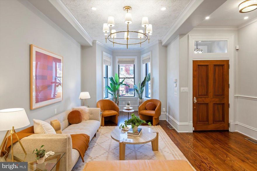 OPENS CANCELLED - UNDER CONTRACT!  A grand Capitol Hill townhome, recently renovated to perfection!  No detail has been overlooked, no shortcuts taken.  Top quality materials and finishes were used to create a luxurious modern home within a historic shell.  The location, just a short stroll to the Supreme Court, US Capitol complex and Union Station, is considered to be among the most desirable on Capitol Hill.  Enter through custom mahogany doors, past the vestibule and into the vast open plan living and dining rooms featuring gleaming wood floors and extra-tall coffered ceilings with custom wallpaper and designer light fixtures.  Note the rounded edges on all corners.  Beyond is a chef’s dream kitchen with oversized glass doors leading to the spacious rear deck, ready for outdoor living and entertaining.  There is ample room for two car parking with the convenience and security of a roll up gate.  There are 4 bedrooms on the upper levels:  3 with exquisite en-suite bathrooms – plus a full hall bathroom and spacious laundry area with side-by-side washer and dryer.  Custom built-in cabinetry has been installed in all bedrooms and bathrooms, adding to the luxury hotel vibe.  The English basement level has been turned into a beautifully-finished two bedroom rental unit with independent front and rear entrances, perfect for guests, family and friends or as a source of rental income.  This grand home is guaranteed to impress!