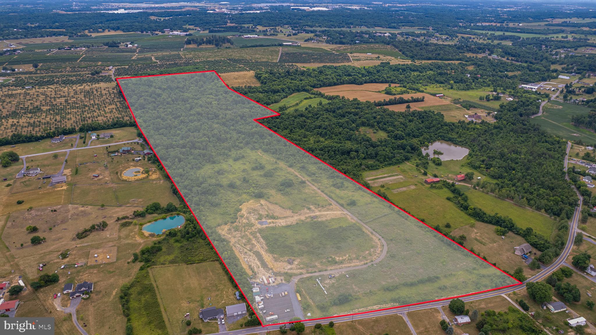 84+/- acres near I-81. Lots of possibilities for this large piece of land. Sections of the property are cleared with some wooded areas. There is a 15,000 sq. foot paved parking lot on the property.