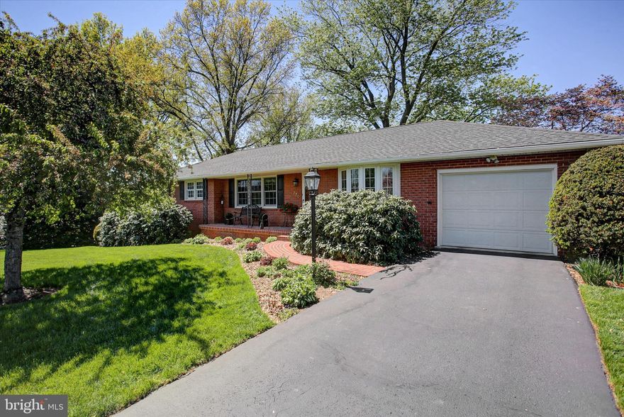 BRICK RANCHER that is inviting from the 1st look!  This well loved home is situated on a quiet street and offers lots of updates in the past 5-6 years.   Featuring 3 bdrms and 1 1/2 baths on main level with updated kitchen & baths and a large sunroom with lots of natural light.  Full walk-out to grade basement offers large rec room and 1 car garage, plus 1 car garage on main level.  Enjoy the peaceful backyard from the rear deck.  Updates include new roof (2020) and new HW heater & pressure tank and other updated touches both inside and out.  Just minutes to town and PA/MD line.