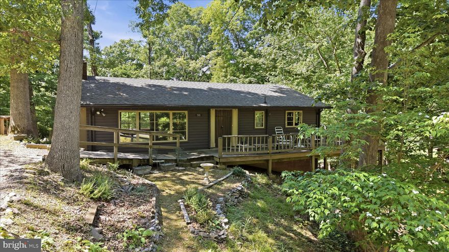 Secluded log cottage in majestic forest with nearby access to the Shenandoah River.....community boat ramp and picnic area,  community water system, road maintenence and snow removal. Located just outside Front Royal and nearby I-66. Brick fireplace with a cozy wood stove insert, whole house generator, hard wood floors, 12/2019 roof and gutters replaced, (removed old shingles), 08/30/2022 septic tank was pumped. 09/16/2022 the distribution box was replaced as was the sewer line from house to tank and tank to d-box. Basement is a mostly stand up with dirt floor. From the community website: "All of the property owners in the community are part of the Shenandoah Shores Sanitary District, which was originally established in 1971. The Sanitary District is currently operated through the Shenandoah Shores Property Owners Association, Inc. (SSPOA), which is responsible for maintaining the streets, street signs, and water supply systems within the community.  (Sanitary Dist taxes included in the real estate taxes.) While membership in SSPOA is voluntary, a portion of real estate taxes paid to Warren County are allocated to the SSPOA to provide these necessary services to the residents of Shenandoah Shores."