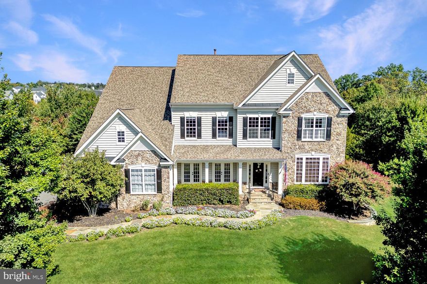 An exceptional opportunity to own one of the finest homes currently available in The Park at Belle Terra. This impressive executive residence offers more than 5,700 square feet of beautifully appointed living space with five bedrooms and four and a half bathrooms, all set on a picturesque ¾ acre lot backing to community open space with scenic views.
<br><br>
The home immediately impresses with striking curb appeal including a stone front exterior, landscaped walkway, welcoming covered porch, and a side-load three-car garage. Inside, the grand two-story foyer showcases elegant trim work, decorative columns, neutral tones, and a sweeping curved staircase. Rich wood flooring enhances much of the main level, creating a warm and refined setting.
<br><br>
The thoughtfully designed main level offers a balance of elegance and functionality with a formal dining room featuring a tray ceiling and detailed moldings, a bright living room with French doors that open to the front porch, and a private study with custom built-ins and glass French doors. The inviting family room includes plush carpeting, a gas fireplace, and access to the screened porch, providing a comfortable space for gathering and relaxation.
<br><br>
The gourmet kitchen is designed to impress with high-end appliances, quartz countertops, subway tile backsplash, a large center island with pendant lighting, and abundant workspace and cabinetry. A sun-filled breakfast area leads directly to the rear deck, making indoor and outdoor entertaining effortless.
<br><br>
Upstairs, the expansive primary suite offers a peaceful retreat with large windows, a spacious sitting area, and a convenient bar with mini refrigerator. The luxurious bathroom features a soaking tub, walk-in shower, and dual walk-in closets with custom storage solutions. Additional bedrooms are generously sized with plush carpeting and walk-in closets. One bedroom includes a private ensuite bath, while two others share a well-designed Jack and Jill bathroom. A convenient upper-level laundry room with utility sink adds everyday practicality.
<br><br>
The walk-out lower level includes a private au pair or in-law suite complete with a bedroom and full bathroom, along with ample unfinished space ready to be customized to suit future needs.
<br><br>
Outdoor living spaces make this property truly special. The cathedral ceiling screened porch features surround sound and ceiling fans, while the large deck overlooks a fenced backyard ideal for entertaining or relaxing. The patio includes a fully equipped outdoor kitchen with built-in grill, exterior refrigerator, and a stone bar, creating a perfect setting for gatherings or quiet evenings outdoors.
<br><br>
This remarkable property combines space, elegance, and a beautiful natural setting within one of the area’s most desirable communities.