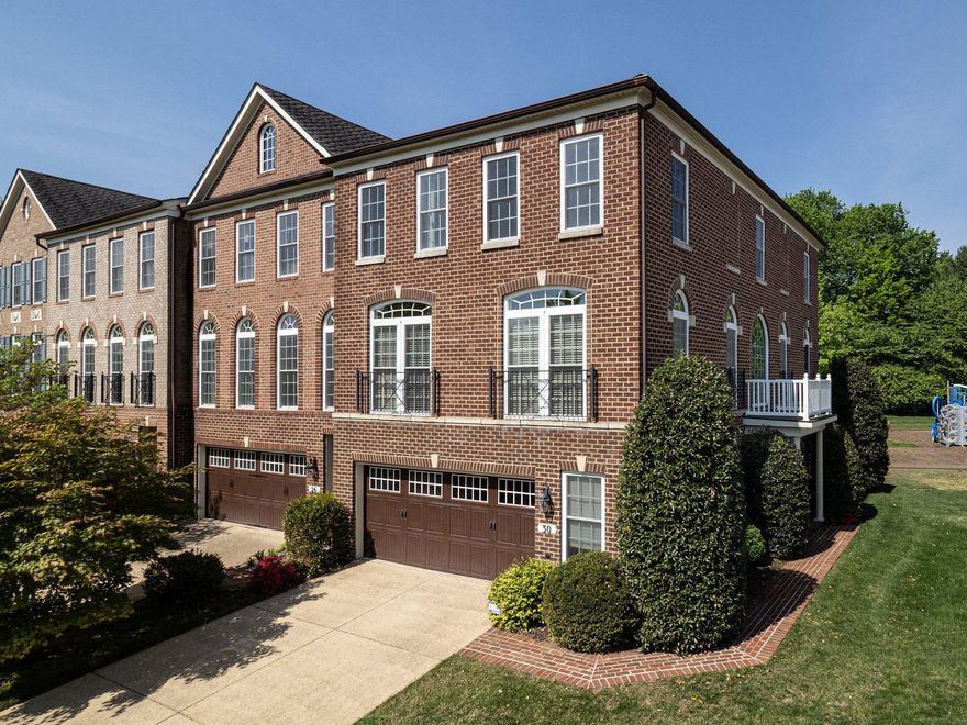 This exquisite brick townhome has nearly 3,000 sq feet of immaculate living space.  The entry level features an expansive recreation area with a fireplace, full bath and oversized two-car garage. Reaching the main living area, you are welcomed by sun-drenched living areas with rich hardwood flooring, extensive moldings and architectural columns. The formal living and dining rooms share an open area perfect for grand entertaining. The spacious kitchen shares space with a breakfast area and family room. The kitchen has cool granite countertops, premium hardwood cabinetry and stainless steel appliances. Enjoy serene green space from the back deck which is accessed from the breakfast area. The upper level features three bedrooms, a hall bath and laundry room. The owners’ suite is an oasis with a tray ceiling, oversized walk-in closet, and a sparkling private bath with premium ceramic tile flooring, dual vanities, and spa-like shower. Rarely does a townhome offer this combination of space, light, and location. As an end unit, it has an extra ten large windows that fill every space with natural light making it feel like a luxurious single family home. The location is minutes away from grocery stores, shops and entertainment at Rio, Crown and Kentlands. The property is currently assigned to Fields Road ES, Ridgeview MS and Quince Orchard HS. Starting the 2027-2028 school year, the assignments are planned to transition to Frost MS and Wootton at Crown HS. See MCPS for detailed information.