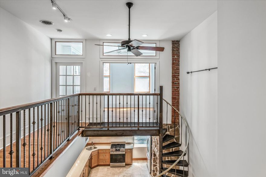 Stunning elegance and sophisticated charm abound in this two-bedroom one and a half bath unit. Flush with architectural details, the high ceilings, brick and stone walls, French doors, hardwood floors, decorative tile flooring, ornamental fireplaces combine to provide this bi-level unit with exceptional aesthetic appeal. The upper level boasts California Closet built-ins in the shared office/bedroom to deliver the perfect work from home environment while adding extra ample storage space in the primary dressing area. An outdoor patio is found off the primary bedroom. On the lower level, the eat-in kitchen with granite counters and stainless steel appliances opens to a living room with a medallion tile flooring. An elegant armoire furnishes another storage option is found on this level. This small boutique building is located in the walkable Bella Vista neighborhood with just the right mix of residential living, shopping and dining options.