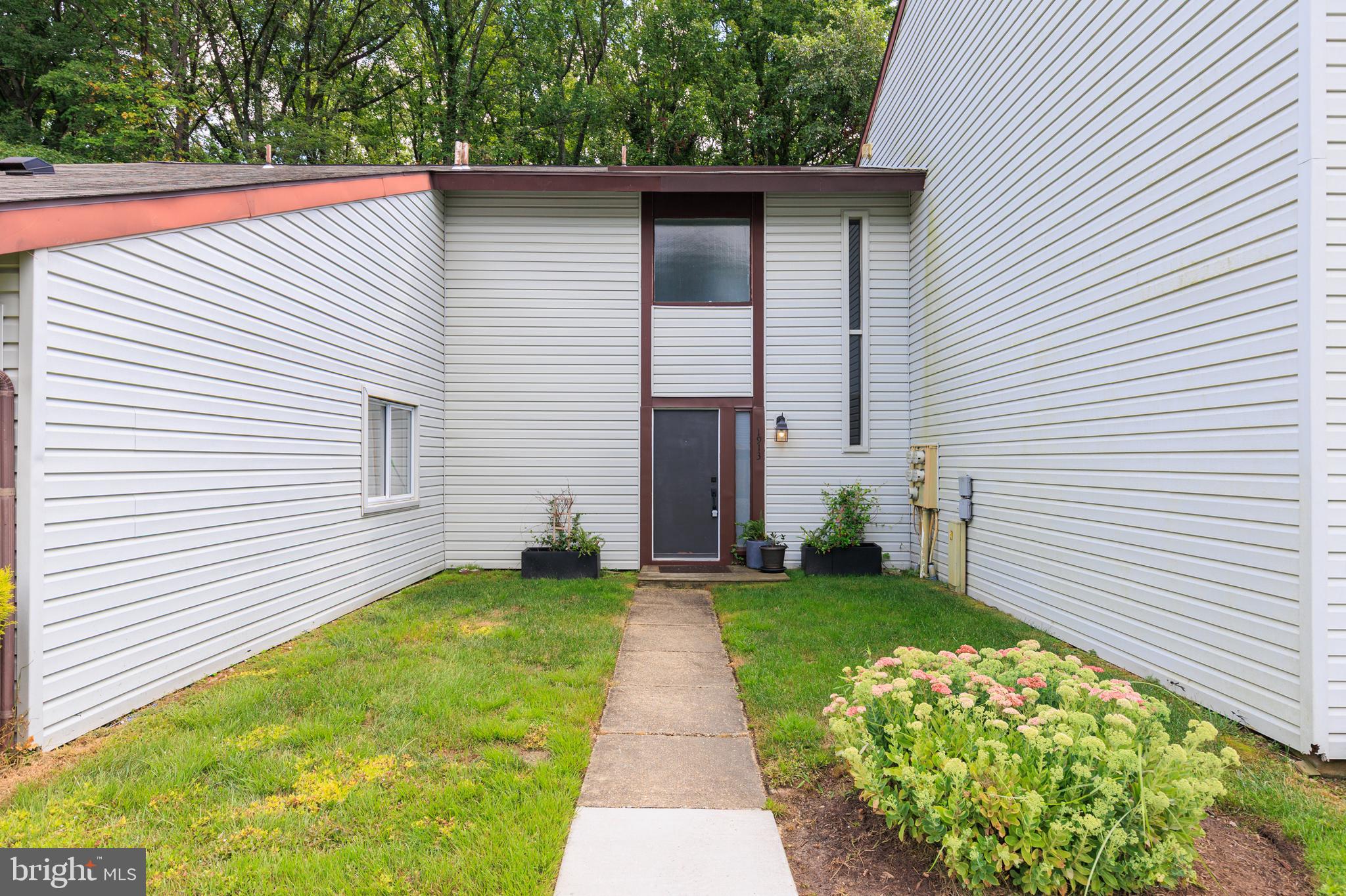 Bright and move-in ready! This wonderful 2 bedroom, 1 bath condo with a separate 1-car garage. Blending low-maintenance living with a private outdoor space. The main level features durable Pergo flooring and an easy, open flow from the living area to a backyard deck and fully fenced yard—all backing to woods for extra privacy. The updated kitchen offers granite countertops and plenty of cabinet space. Two comfortable bedrooms and a bright full bath complete the home. Enjoy the convenience of garage parking plus a prime Crofton location close to shopping, dining, parks, and commuter routes. A standout value for anyone seeking comfort, privacy, and convenience in Crofton!