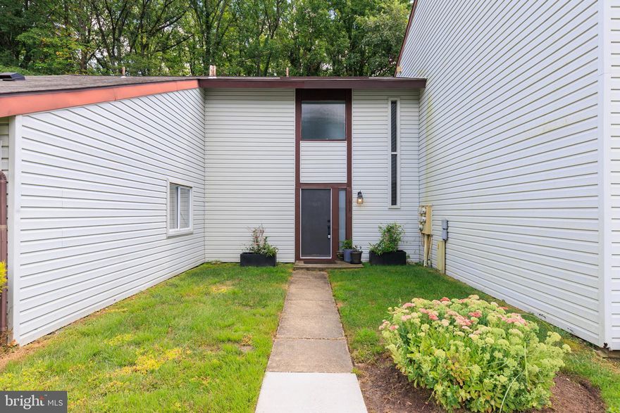 Bright and move-in ready! This wonderful 2 bedroom, 1 bath condo with a separate 1-car garage.  Blending low-maintenance living with a private outdoor space. The main level features durable Pergo flooring and an easy, open flow from the living area to a backyard deck and fully fenced yard—all backing to woods for extra privacy. The updated kitchen offers granite countertops and plenty of cabinet space. Two comfortable bedrooms and a bright full bath complete the home. Enjoy the convenience of garage parking plus a prime Crofton location close to shopping, dining, parks, and commuter routes. A standout value for anyone seeking comfort, privacy, and convenience in Crofton!