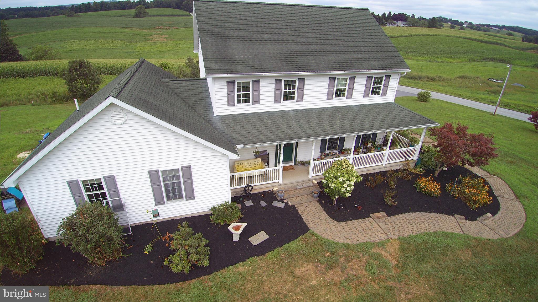 If the sounds of nature are what you're looking for in your next home, then you have found it. Shes not sitting in a development, she's not asking for a HOA every month, she's sitting in the middle of a cornfield watching the CROWS fly by on her back deck. She is standing tall and proud with 2700 plus feet to share with you. Four bedrooms and a master suite on the first floor with private bath and gas fireplace leading off to the deck for midnight magic and star gazing, two closets, one being a walk-in closet. Two family rooms, open floor plan, with kitchen, dining and living room. Large wrap around porch, Geo-thermal heating system, poured concrete walls, walk out basement. A full basement you can also finish for future enjoyment