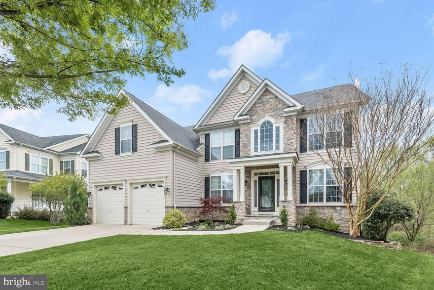 Open House has been canceled. So sorry for the inconvenience. Welcome to this beautiful 5-bedroom Colonial, boasting nearly 5,000 sq. ft. of luxurious living space with updates including interior paint, carpet, kitchen, and more. As you approach, you'll notice the rustic stone detail on the covered front porch, adding charm to the exterior. Step inside the sun-filled 2-story foyer, highlighted by hardwood flooring and architectural columns, opening to formal living and dining rooms adorned with accent molding. The bright and airy open concept floor plan includes a chef’s kitchen, breakfast room and family room, highlighting a cozy fireplace, creating the perfect space for everyday living and entertaining. You’ll love entertaining in the spacious kitchen that features tastefully renovated cabinets, black granite countertops, custom backsplash, an island breakfast bar, stainless appliances, and offers access to the deck for outdoor enjoyment. On the main level, you’ll find a flex space, perfect for a private home office or kids playroom. For added convenience, there’s a laundry room and powder room on the main level.  Retreat to the spacious primary bedroom suite, complete with an impressive tray ceiling, a huge walk-in closet with a window, and an attached luxury bath featuring a jetted tub, separate shower, and a dual vanity. Three additional bedrooms, two additional bathrooms, and a second home office option or potential 5th bedroom complete the upper level. The finished lower level offers additional living space with a bedroom and full bath, a recreation room, exercise room, and abundant storage, with French door walkout to the backyard. Outside, the expansive deck provides a tranquil tree-lined view, perfect for relaxation. Community amenities included a recently renovated clubhouse, community pool, tennis courts, tot lots, trails and so much more. Situated between Baltimore and Washington D.C., this home offers convenient access to major commuter routes, parks, shopping, dining, and entertainment options. Don't miss out on this fantastic opportunity!