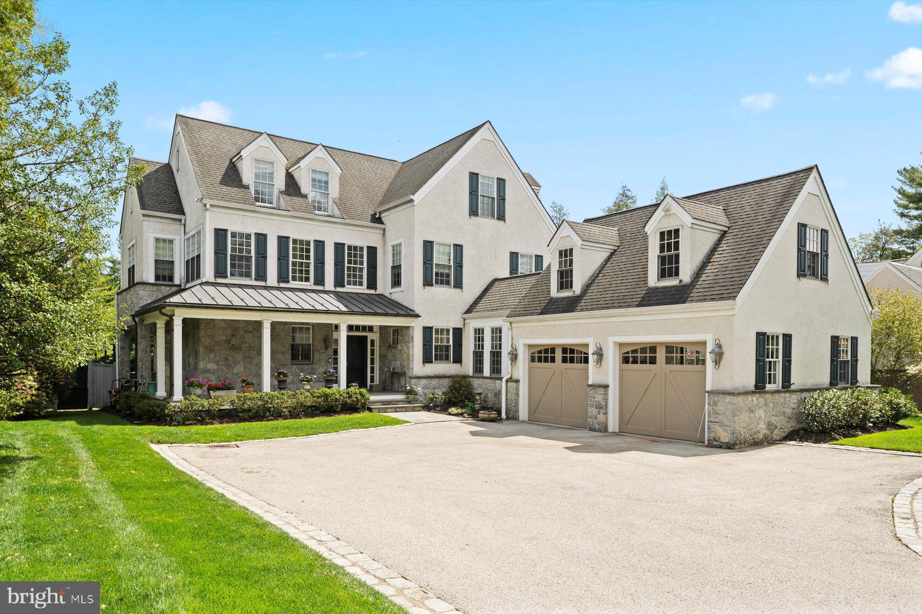 If you’ve been dreaming of a home that has everything: style, space, comfort and luxury, this one's for you! 510 Auburn Avenue is a charming farmhouse-style home that seamlessly blends timeless tradition with rustic elegance, offering the perfect space for creating a lifetime of fabulous memories.
Nestled in the heart of Wyndmoor, this custom-designed home built in 2006 spans over 6,600 square feet on a .42 acre lot. Wyndmoor is one of those hidden-gem communities that feels like a small town but is super close to the city. It’s part of Springfield Township in Montgomery County, and people love it for its walkability, welcoming vibe, and tree-lined streets. You’re just minutes from Chestnut Hill shops and restaurants, beautiful parks, and easy train access into Philly. Great schools and a strong sense of community make this area extra appealing. From the moment you arrive, you’re greeted by beautifully manicured landscaping that sets the tone for what’s ahead. The wrap-around porch invites a warm welcome while promising a serene outdoor retreat. The impressive exterior boasts a mix of gables and varied roof heights perfect for a traditional farmhouse silhouette, with a natural stone and stucco exterior. In front of the house is a 2-car garage with a matching roof that enhances the home’s curb appeal.
The entrance hall leads into a floor plan that is designed with comfort and connection in mind. Flowing beautifully, the main level is ideal for both everyday family living and effortless entertaining. The chef’s kitchen features premium appliances, expansive counter space, and a centrally located wet bar perfectly positioned between the kitchen, living room, and family room, making the design ideal for hosting or just kicking back with the family. The kitchen’s bright dining space is anchored by roomy banquette seating along a set of windows, making it a cozy spot for everything from family meals to morning coffee. Adjacent to the kitchen, you’ll find a relaxed family room lined with windows. The home flows effortlessly into a spacious living room with vaulted ceilings and charming farmhouse-style exposed beams. A striking stone fireplace anchors the space which is perfect for gathering with friends or enjoying a movie on the screen mounted above. Both the living room and adjacent family room open onto an exquisite bluestone patio overlooking a private backyard. The yard is beautifully framed by mature landscaping and towering green giants, creating a peaceful, secluded retreat. For additional entertaining space, the main level includes a private dining room with farmhouse flair. Rounding out this level are two convenient half baths and a well-equipped laundry room, complete with a built-in dog wash station because your four-legged friends deserve a little luxury, too!
This 3 story home with a lower level offers 6 fabulous bedrooms, 5 full bathrooms, 2 half bathrooms and a spacious third floor office with a picturesque view overlooking the property. Natural light pours in through high-end Pella windows, brightening every corner of the home. Generously sized walk-in closets and abundant storage are found throughout, combining function with comfort.The bright lower level is an entertainer’s dream, featuring a custom wet bar with a beer tap, dishwasher, and custom cabinetry. You'll also find a fully equipped home gym with a full bathroom and steam shower, plus a cheerful craft room and a cozy family room perfect for movie nights or game days. The bedroom and full bath on the lower level is perfect for an au pair or guest space.
Every detail of this home has been carefully considered, from the impeccable millwork to the fine finishes throughout. A true blend of luxury, comfort, and character, this exceptional home was thoughtfully designed to be both lived in and loved, making 510 Auburn Avenue an absolute must-see!