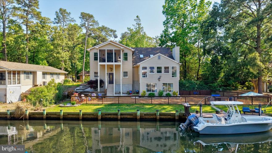 Comfort, privacy, and waterfront living come together in this fully renovated three-level contemporary home, ideally positioned along one of the quietest canals in Ocean Pines with direct access to the bay and beaches of Ocean City. Offering 4 bedrooms, 3.5 baths, and approximately 3,250 square feet, this exceptional residence has been thoughtfully updated to provide the perfect blend of coastal comfort, functionality, and entertaining space.   Designed with an open-concept layout, the home features soaring vaulted ceilings, skylights, and expansive windows that fill the interior with natural light while showcasing tranquil water views from all three levels. Multiple gathering areas throughout the home allow family and guests to comfortably spread out, including a spacious great room, waterfront den, and bar area adjacent to the kitchen.  The middle level also offers a private guest suite with en suite bath for those wishing to avoid stairs, an additional powder room, laundry room, and direct access to the oversized multi-car garage with front and rear access points.   Upstairs, the primary suite serves as a true private retreat, spanning approximately 768 square feet and featuring its own three-season porch overlooking the water. This luxurious space includes a large walk-in closet, natural gas fireplace, and beautifully renovated spa-style bath complete with extensive cabinetry, dual-person Jacuzzi soaking tub, and walk-in wall-jet shower. Two additional bedrooms, two porches, and another full bath complete the upper level.   The ground level offers even more flexibility with two freshly renovated waterfront rooms ideal for entertaining, relaxing after a day on the water, or hosting the perfect crab feast. Walls of windows and sliding glass doors provide panoramic canal views and direct access to one of the largest waterfront backyards in Ocean Pines. The oversized .35-acre lot includes a full-length fenced yard, expansive private bulkhead, maintenance-free dock with fish cleaning station, hardscape walkways, and ample room for kayaking, crabbing, pets, and outdoor gatherings.  Extensive 2026 renovations include a full interior repaint, all new luxury vinyl plank flooring, carpet, and ceramic tile throughout, remodeled kitchen and baths, a fully renovated third level with dedicated mini-split HVAC system, updated plumbing and lighting fixtures, new vanities with quartz and marble countertops, updated toilets, ceiling fans, and more. Additional highlights include three-zone heating and cooling, instant hot water system, air purification system, dehumidification system, fire and alarm monitoring with cameras, oversized garage with 9-foot door for possible boat storage, and parking accommodations for up to 6+ vehicles.   The home also offers a full concrete crawlspace with convenient interior access to mechanical systems including the furnace, plumbing, dehumidifier, air purification equipment, and AirBoss controls. Pride of ownership is evident throughout, with the roof and multi-zone HVAC systems regularly cleaned and professionally serviced.   Move-in ready and meticulously maintained, this rare waterfront offering combines peaceful coastal living with convenient access to the bay, ocean, dining, marinas, and entertainment of the greater Ocean City area.