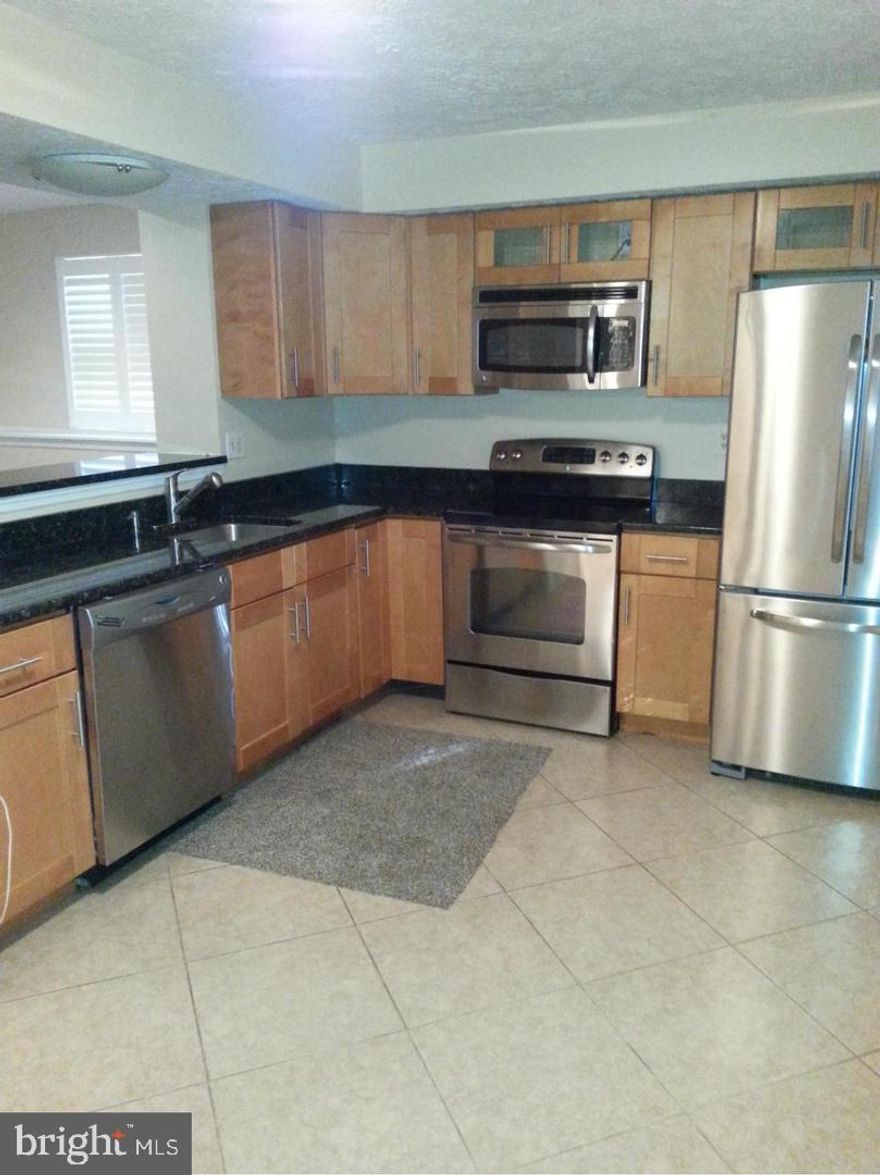 Cozy 2-bedroom 2 bath ground unit rental with French doors off living room to open back yard. Large kitchen with granite counters, and stainless appliances including French door refrigerator, glass top stove, dishwasher and microwave. Washer and dryer in laundry closet. New carpeting and paint throughout. Customer tiled baths with elegant vanities and light fixtures. Minimum income $72,000