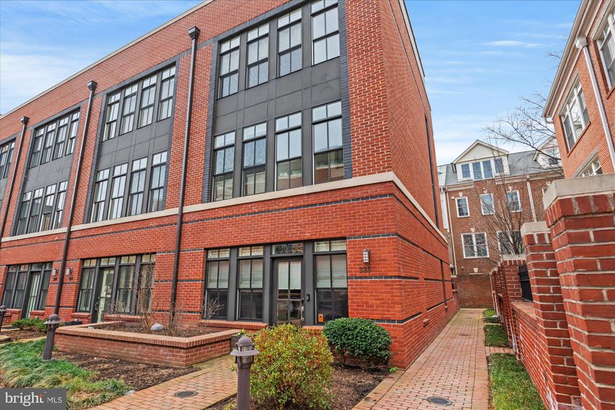 Luxurious living in exclusive Printers Row! This meticulously maintained, end-unit townhome is defined by its modern style, featuring a bright and open main level floor plan, high windows, 10-foot ceilings, and several private outdoor spaces. The spacious main level features an oversized dining space, gorgeous kitchen, a large living room, convenient half bath, pantry, and a private outdoor patio - great for summer BBQs! The kitchen is a chef's dream with quartz counter-tops and island, white subway tile backsplash, ample cabinetry, Wolf gas range, Zephyr hood and Kitchen Aid refrigerator and dishwasher. Head upstairs to the second floor, which is dedicated to the beautiful primary bedroom suite. This serene retreat features a balcony, a spa-like ensuite bath and amazing closet space with customized shelving. The primary bath has a double vanity, walk-in shower and Victoria & Albert bathtub. The third floor boasts two large bedrooms with great closet space, a shared hall bath and laundry. On the fourth floor is a lofted living room with a wet bar. Head outside to the private, two-tiered rooftop deck with views of the Potomac River and DC! This private, gated enclave of North Old Town is situated steps from the Mt. Vernon Trail with access to many restaurants such as Hank’s Oyster Bar, Oak Steak House, Sisters Thai, Café 44 and St. Elmo’s Coffee among others. Trader Joe’s and Harris Teeter are within walking distance, so you can leave the car at home (2 garage spaces - one with an EV charger!). Less than a mile to the Braddock Road Metro, two traffic lights to DC, and a short drive to Reagan National Airport, this home is ideal for commuting! Welcome Home!