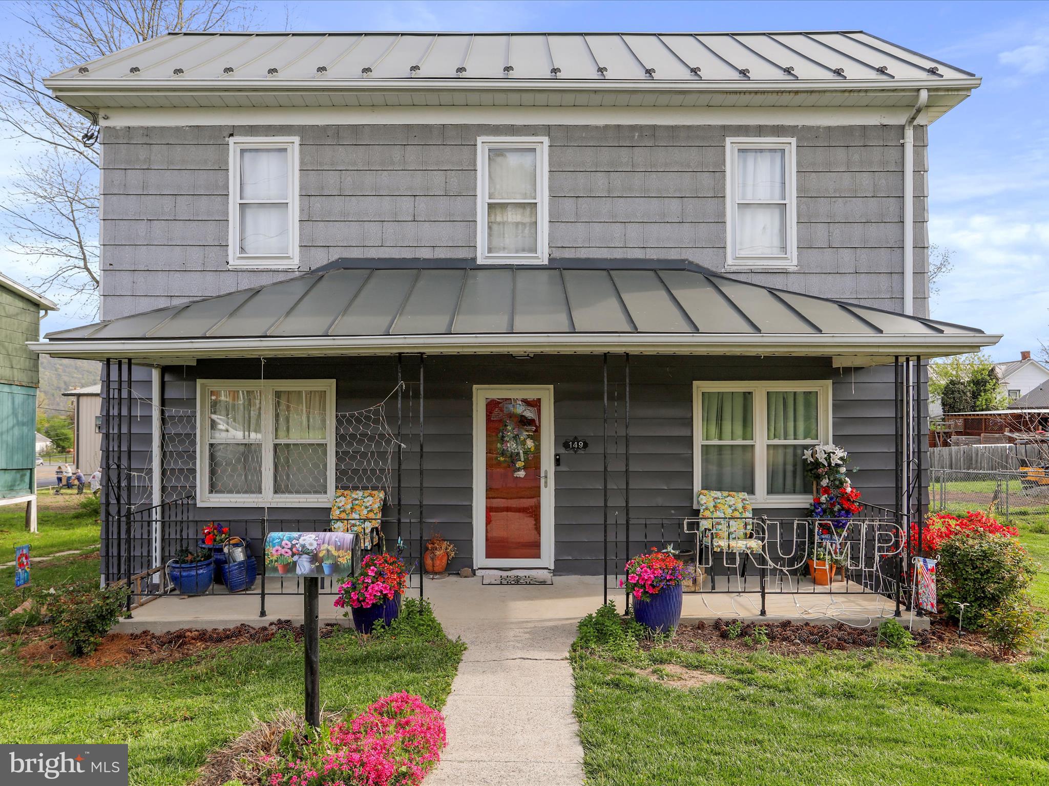 Charming downtown home with all the new bells and whistles. The home offers a multitude of big ticket upgrades completed recently. On the exterior of the home, the standing seem metal roof was installed to offer the best protection for many years. You will also find new fencing in the backyard and new HVAC pump for the central heat and a/c in the home. The detached garage has a window a/c unit, a new door with garage door opener. The backyard of the home is a large lot with plenty of room for outdoor living space and play area. There is a wonderful screened in porch on the back of the home that overlooks the large backyard. The front of the home has a covered porch for additional outdoor space. As you walk into the front level entrance, you will find the living room with a large case opening into the dining room and kitchen. The interior of the home boasts a fresh coat of paint on the ceilings and walls. New flooring has been installed on the first and second floors. There is a main level bedroom and full bath. The full bathroom on the main level has a new shower installed. Laundry hook-ups are also on the main level. The kitchen boasts new granite counter tops. The home has new light fixtures. On the second level, there is a second full bathroom and a bonus room with storage space, additional laundry hook-ups and a kitchenette area. The location of the home is within walking distance to Main St in Romney that has shopping and coffee shops. Come and see this spacious property in a great location in downtown Romney!