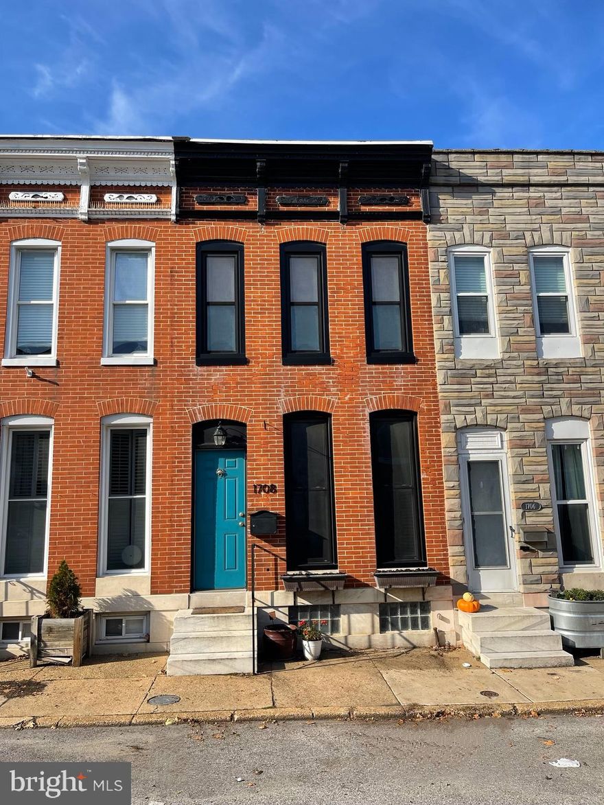 Striking home in Historic Federal Hill features all modern updates . Comfortable living space starts in the entry room anchored with a gorgeous brick exposed wall. The kitchen is tastefully updated to include granite, stainless steel appliances, and white cabinetry. The living room joins a great size dining room. The main level has a fully updated bathroom, and door to the back entry with a two-car parking pad. The upper level includes three bedrooms and a beautifully updated bathroom. The owner's bedroom has a wonderful size closet, three front windows, and high ceilings. Rooms are of generous size and have ample closet space. High ceilings, with multiple windows, offer lots of natural light to flow through. The lowest level offers exceptional storage and a back door to walk-up to the back. This home is steps to all major city attractions, restaurants, and commuter routes.