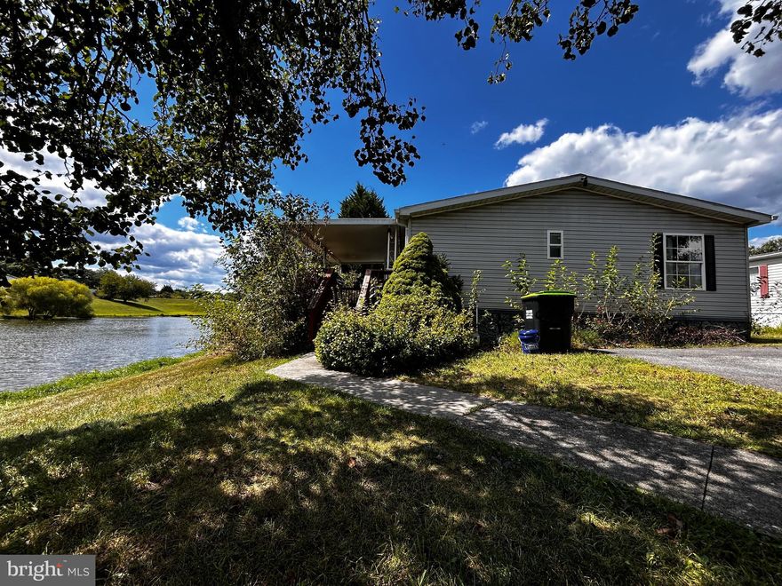 Resort-Style Living at Regency Lakes! This spacious manufactured/mobile home offers beautiful water views and a low-maintenance lifestyle.   Enjoy your morning coffee or evening sunsets from the large deck overlooking the lake. Inside, the open floor plan features a generous kitchen with an island and abundant cabinet space, perfect for cooking and entertaining. The primary suite includes an attached bath with a relaxing soaking tub and separate shower. A convenient laundry room adds extra functionality.  Enjoy an amenity-rich community that also offers easy access to route 7 and many shopping and dining options nearby. There is no HOA fee, just lot rent $925.