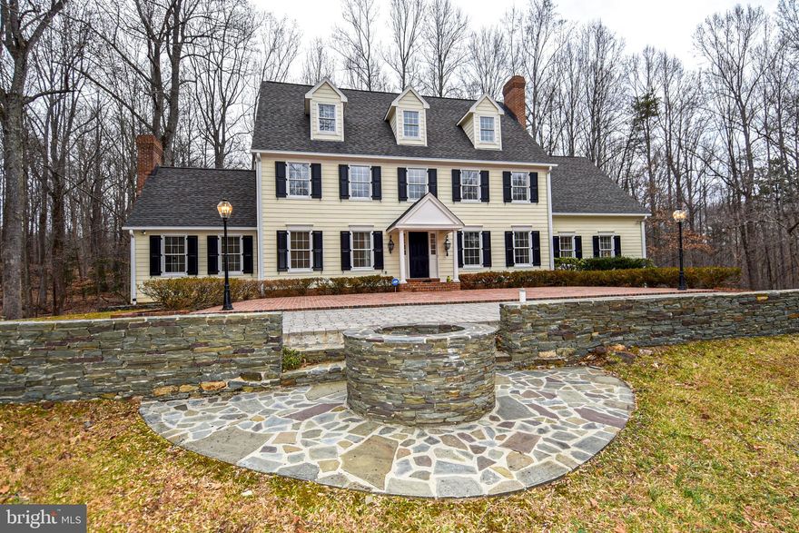 BEAUTIFULLY SITED STATELY COLONIAL HOME ON OVER 6 WOODED ACRES IN SOUGHT AFTER FAIRFAX STATION SHADOWALK COMMUNITY IS READY FOR ITS NEXT LUCKY FAMILY * WITH 4 LEVELS, BOASTING OVER 4700 SQUARE FEET OF FINISHED SPACE ON 3 LEVELS, PLUS AN ADDITIONAL 1000+ SQUARE FEET IN AN UNFINISHED WALK-OUT BASEMENT * THE POSSIBILITIES ARE ENDLESS * 5 BEDROOM AND 5 ½ BATHS * HOME FEATURES 4 WOOD-BURNING FIREPLACES, TWO OF WHICH HAVE BEEN CONVERTED WITH GAS LOGS. * HARDWOOD FLOORING THROUGOUT THE HOME * THE HOME HAS BEEN FRESHLY PAINTED AND THE KITCHEN FEATURES BRAND NEW STAINLESS APPLIANCES * ENTER THE PROPERTY VIA THE ELEGANT HORSESHOE DRIVE LEADING TO THE LARGE FORMAL BRICK TERRACE ENTRANCE OR SPACIOUS PRIVATE SIDE LOAD OVERSIZED 2 CAR GARAGE * AS YOU APPROACH THE MAIN HOUSE, DON’T MISS THE CIRCA 1850 HOME FOUNDATION WHICH HAS BEEN TRANSFORMED INTO A COZY OUTDOOR FIREPIT AND SEATING AREA * ADJACENT IS THE CURRENT BARN, WHICH INCLUDES 4 HORSE STABLES * THE REAR, NORTH SIDE OF THE PROPERTY, IS WOODED AND IS BORDERED BY A CREEK * YOU WILL ENJOY GREAT SCENARY FROM THE SCREENED PORCH AND LARGE DECK, WITH NEW COMPOSITE DECKING AND RAILINGS * THE COMMUNITY FEATURES MILES OF HORSE TRAILS AND IS MINUTES FROM FOUNTAINHEAD REGIONAL PARK *THIS PROPERTY PROVIDES PRIVACY AND OFFERS THE BENEFITS OF A COMMUNITY * AN EXCEPTIONAL VALUE FOR THIS MUCH HOME AND LAND!