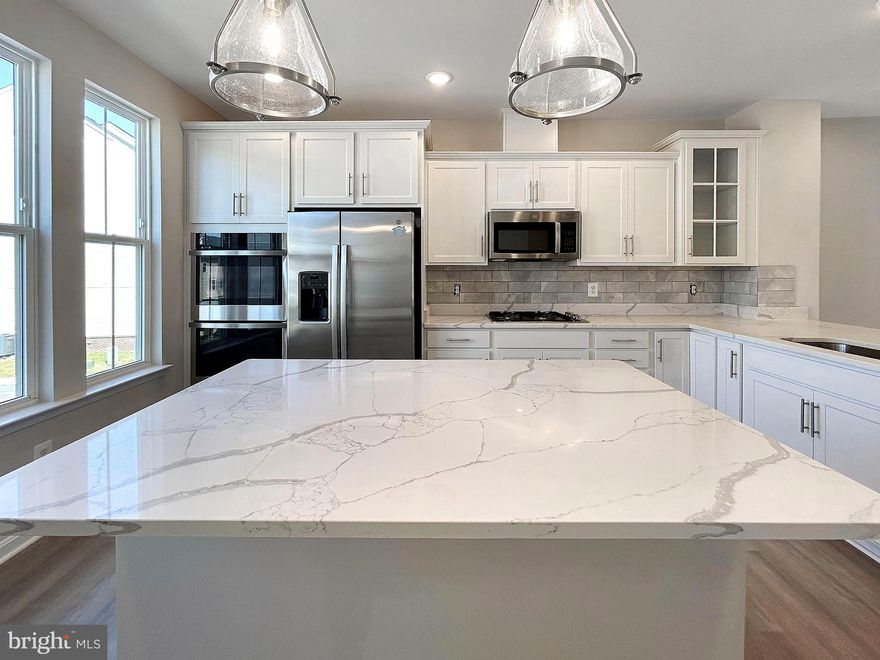 Indulge in the pinnacle of luxury living with this stunning 3-bedroom townhouse, boasting 2 full and 2 half bathrooms. This modern, newer-construction home seamlessly blends sophistication and practicality, featuring a 2-car garage and an array of premium upgrades. The gourmet kitchen is a chef’s dream, showcasing sleek quartz countertops, top-of-the-line stainless steel appliances, and elegant luxury vinyl plank flooring. On the entry level, a versatile office space and convenient half bathroom offer flexible living options tailored to your needs.

Designed for effortless living, this maintenance-free urban oasis includes an in-unit washer and dryer, while placing every essential within walking distance. Just 1 mile from Route 15, the Towns at Market Commons are surrounded by an abundance of shops, restaurants, grocery stores, and entertainment, redefining the urban lifestyle. A short drive from the historic allure of Downtown Frederick, this townhouse is the perfect retreat for those seeking style, convenience, and comfort in one exceptional package.