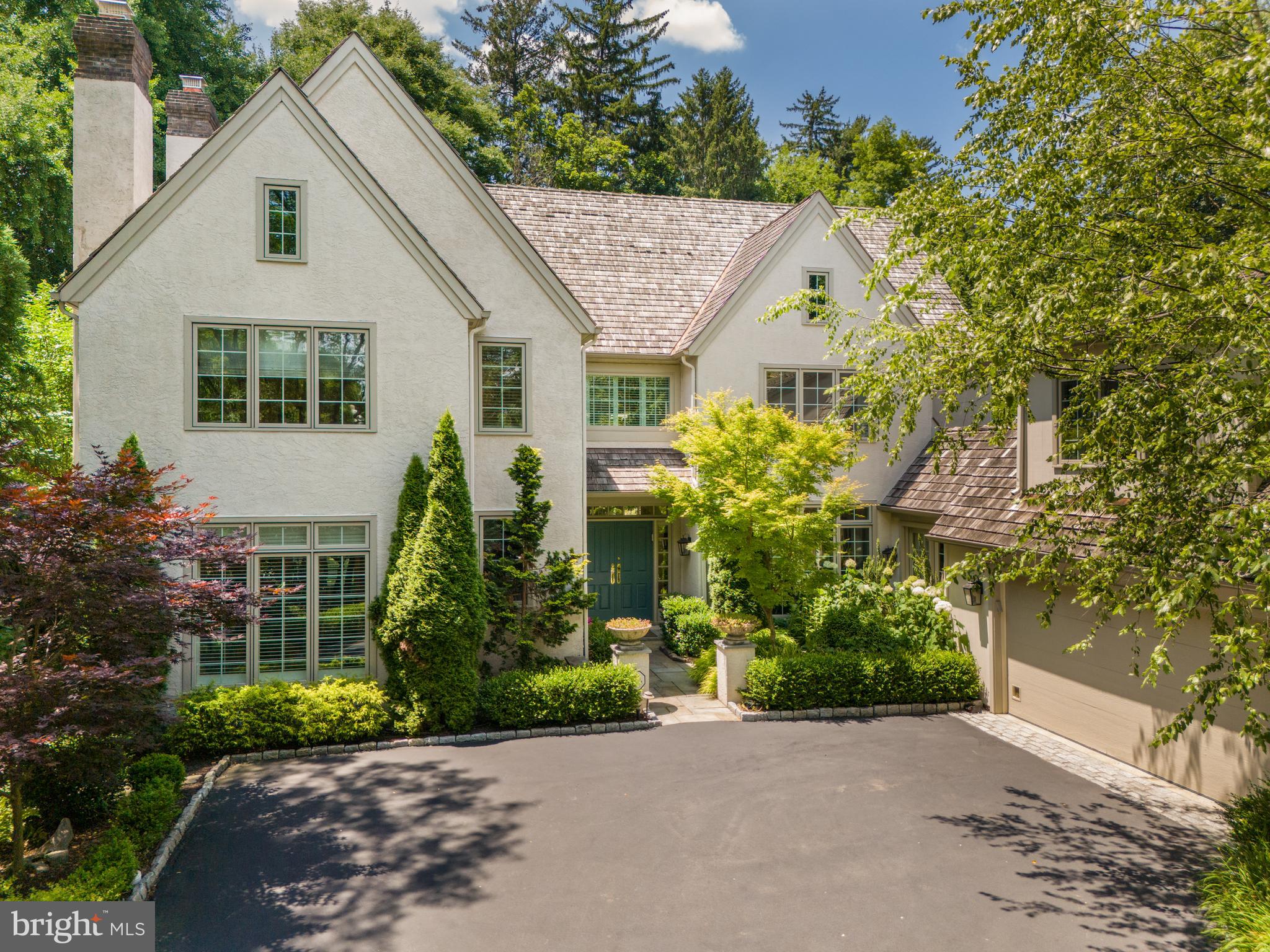 Welcome to 1222 Denbigh Lane, an exquisite 5-bedroom, 4.5-bathroom English Country style home located in the prestigious Denbigh Estates Community. This remarkable residence is surrounded by acres of open space and scenic trails, offering an unparalleled living experience. With its refined architecture, artisanal craftsmanship, and exceptional interior design, this home epitomizes elegance and sophistication.
Upon arrival, you are greeted by a professionally landscaped grand entrance, featuring vibrant garden beds and meticulously maintained hedges lining the winding driveway. A paver walkway leads to the covered front entrance, setting the tone for the elegance within. Step through the double doors into a vast two-story foyer, adorned with gleaming hardwood floors and tasteful crown molding. To your left, the elegant living room is decorated with a marble surround gas-burning fireplace with a wooden mantle, custom built-ins, two discerning chandeliers, a magnificent built-in fish tank, and crown molding. The living room opens to the expansive rear patio through glass French doors, creating a seamless transition between indoor and outdoor living spaces.
Opposite the foyer, the formal dining room boasts custom built-ins, hardwood flooring, and crown molding. Nestled at the back of the home is your gourmet eat-in kitchen, showcasing sleek quartzite countertops with a Sri Lankan Volcanic Stone backsplash, commercial-grade appliances including three refrigerators, an abundance of custom wooden cabinetry, a large center island with barstool seating and a secondary sink, an expansive pantry, and a baking/coffee bar for added convenience. The hardwood flooring leads to the breakfast room, offering oversized windows that provide captivating views of the serene waterfall.
Open to the kitchen and breakfast area, the magnificent great room features an ultra-high ceiling, a marble-surround gas fireplace, custom floating wooden cabinets, a custom built-in bar with two wine fridges, and glass french doors that provide direct access to the rear yard. The first floor is completed with two-car heated garage access, a tiled mudroom with heated floors, a recently upgraded powder room, and additional space with a fireplace, ideal for a fitness studio or office.
Ascend the grand front staircase to the second floor to find the primary suite, masterfully detailed with hardwood flooring, dual walk-in closets, and recessed lighting. The spa-like exclusive ensuite bath is equipped with heated floors, a dual vanity, a soaking tub, a glass-enclosed tiled shower, and a remote-controlled Toto toilet. Three additional bedrooms, each with hardwood flooring and ample closet space, share a tastefully updated full hall bathroom with heated floors. The fifth bedroom is an ensuite, accessed by a private staircase off of the mudroom area, featuring a large closet and its own private bathroom with heated floors.
The substantial lower level is perfect for hosting gatherings, offering a custom in-home movie theater with seven leather reclining seats, an immense flex space that can accommodate a bedroom or office area, a fully updated bathroom, an abundance of storage opportunities, a large tiled laundry room with a utility sink, and a woodshop.
The exquisite, tree-lined rear yard is a true masterpiece of outdoor living. Featuring a custom flagstone patio perfect for hosting unforgettable gatherings, this lush oasis is adorned with meticulously maintained garden beds and a stunning, elegant waterfall. This enchanting setting provides an unparalleled backdrop for entertaining in style and sophistication.
This exquisite residence at 1222 Denbigh Lane epitomizes elegance and luxury, offering an unparalleled living experience in the heart of Wayne, PA. Situated in the prestigious Denbigh Estates Community, this home enjoys a prime location that balances serene privacy with convenient access to top-tier amenities.
