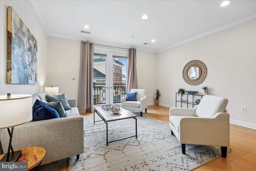 Move-in ready, this southern-facing, light-filled two-level condo offers the feel of a townhome with the ease of low-maintenance living - perfectly positioned above the shops and restaurants of King Farm in Rockville.

Freshly painted throughout, the open-concept main level features hardwood floors, crown molding, and French doors that flood the space with natural light. The kitchen includes granite countertops, under-cabinet lighting, a brand-new refrigerator, and a breakfast bar with generous storage. The dining area is elevated by a Restoration Hardware chandelier, and the powder room showcases a Restoration Hardware vanity and heated/cooling bidet.

Upstairs, two spacious bedrooms each offer renovated ensuite baths and ample closet space. Both bathrooms have been fully updated with new tile, vanities, lighting, and fixtures. The rear bedroom includes pocket doors creating flexible space for a home office, gym, or sitting area. Upper-level laundry adds everyday convenience.

Condo amenities: ample parking (with reserved access), private storage unit, indoor bike storage, community room, and fitness center.

Enjoy easy access to I-270, I-370, Route 355, and the nearby Shady Grove Metro Station (with shuttle and Capital Bikeshare access). Residents enjoy King Farm’s pools, parks, sports courts, dog park, and walkable retail—including Safeway just around the corner. Prime location for the spectacular Rockville fireworks!