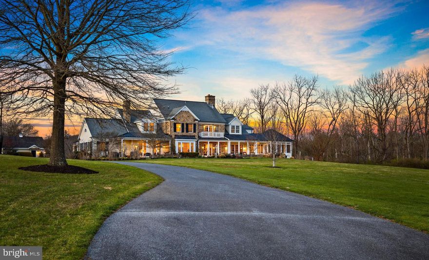 Nestled in Greenspring Valley sits an impressive custom stone and shingle colonial on 15.68 acres of picturesque land, offering stunning  180 degree views, privacy and a peaceful environment. This beautifully designed home boasts over 12,000 square feet  with 5 bedrooms, 4/1 baths and a 2 bedroom, 2  bath in-law suite.  Showcasing attention to detail and craftsmanship, with a touch of elegance and sophistication in every room. This lovely home provides ample space for comfortable family living.  When entering, you are greeted by custom millwork and built-ins throughout, creating a warm and inviting atmosphere. The spacious living room and family room have fireplaces that add a touch of warmth and coziness and the walls of windows and French doors provide an abundance of natural light and invites the breathtaking outdoors into the home. The expansive Gourmet kitchen with custom cabinetry, 10 foot center island w/prep station, walk in pantry, breakfast nook and the handsomely appointed Butler's station is adjacent to the formal dining room is an entertainer's dream. The mudroom and back hallway offer direct access to the oversized 2 car garage plus dog washing station. The upper level's  spacious primary suite has 2 walk in closets, luxury bath and spectacular view. There are 2 additional bedrooms, 2 full baths and a fourth larger bedroom or office plus 2 multi-purpose rooms over the garage and laundry. The lower level has an oversized recreation room with a wet bar, built-ins, ping-pong and pool table. There is also a bedroom, full bath, exercise room, and two extensive utility- storage rooms. One of the most unique features of this estate is the seamless integration of the In-law suite with it's own private entrance. A home in itself with spacious living areas, kitchen, high ceilings, fireplace, built-ins, laundry and so much more. With so many possibilities it allows for multi-generational living or the ability to welcome guests while ensuring everyone has their own comfortable and private living area. The outdoor areas of the property are beautifully landscaped, with hardscaped patios and porches perfect for relaxing and enjoying the natural surroundings.  There is also a screened porch, offering a comfortable space to enjoy the outdoors and the scenic vista.  A charming Amish-built barn serves as a two car garage.  All these wonderful features and amenities combined make this glorious home on 15.68 acres a luxurious and comfortable living experience, providing both functionality and elegance in every aspect of the home.  This lovely home is conveniently located to schools, shopping and is surrounded by  properties in permanent conservation.
