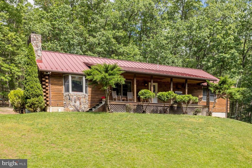 3 bedroom/ 2 bathroom on 2.2 acres, situated just outside of the town of Franklin (Home of the Treasure Mountain Festival). The home was constructed from logs procured by Mountaineer Log and Siding Company out of McHenry, Maryland, in 1998, in accordance with BOCA Building Code requirement. The logs are inter-locking logs. The windows are double-hung, double-pane gasket windows. There is a steel beam that runs the length of the home. The foundation is poured concrete with thickness of 10" to 12" in accordance with BOCA requirements. There is a camper parking pad, equipped with electric. The home has central heating and central air servicing the total square footage upstairs (2110 sf, per previous appraisal) and downstairs (1352 finished sf/704 sf garage). Vaulted ceilings upstairs with wood beams are accented by two etched glass chandeliers and a vintage-style ceiling fan and lighting fixture in the kitchen. The kitchen features double-ovens and an expansive custom kitchen pantry system which includes two tall pantry towers with built in cabinetry, pull-out drawers, upper and lower cabinets and open shelving. The home has two fireplaces, each having their own separate flu. Upstairs fireplace - Propane log-fireplace with remote control and temperature setting control. Downstairs fireplace - Wood burning Pacific Energy Fireplace insert with a full stainless steel flue liner. The basement offers an open concept, featuring a "speak-easy" style entertainment area with 10 Foot ceilings throughout. It also includes an oversized two car garage with drive-in access and a fire-rated safety ceiling to meet code requirements. The furnace is a Trane Energy Efficient gas-fired condensing furnace 100,000 BTU input, up flow-horizontal configuration.  The water heater is an A.O. Smith Propane-fired PowerShot with power venting. Energy Saver Model. Complete well water treatment system, including a Well-Rite pressure tank, water softener with brine tank, a whole-house sediment filter. Providing soft, clear water throughout. The well pump was replaced in Aug 2011 to install a low water cut off. The Roof is a ribbed-lined metal roof which was installed by Skyline Roofing in Dec 2015. The Back Deck - 916 Sq Ft. was completely rebuilt in 2024. The deck includes a 225 Sq Ft. reinforced structural support for a hot tub and access to the crawlspace. Also includes easy access to water and electricity. The whole house generator pad is ready to go! There is a poured concrete pad with the propane lines run to the generator pad and dedicated shut-off switches in basement and a separate power panel. A third bathroom has been fully plumbed in the basement, with water lines and toilet rough-in already for future finishings. Pull-down attic stairs with large attic storage area.
Appliances include: Maytag wall oven, Maytag Super capacity Plus oven, Large Maytag 20.7 Cu. Ft. Refrigerator with ice maker, dishwasher, Garbage disposal, Maytag Quiet Plus heavy-duty washer and dryer set. The bar and pool table (along with the ping-pong conversion set) will remain with the home.