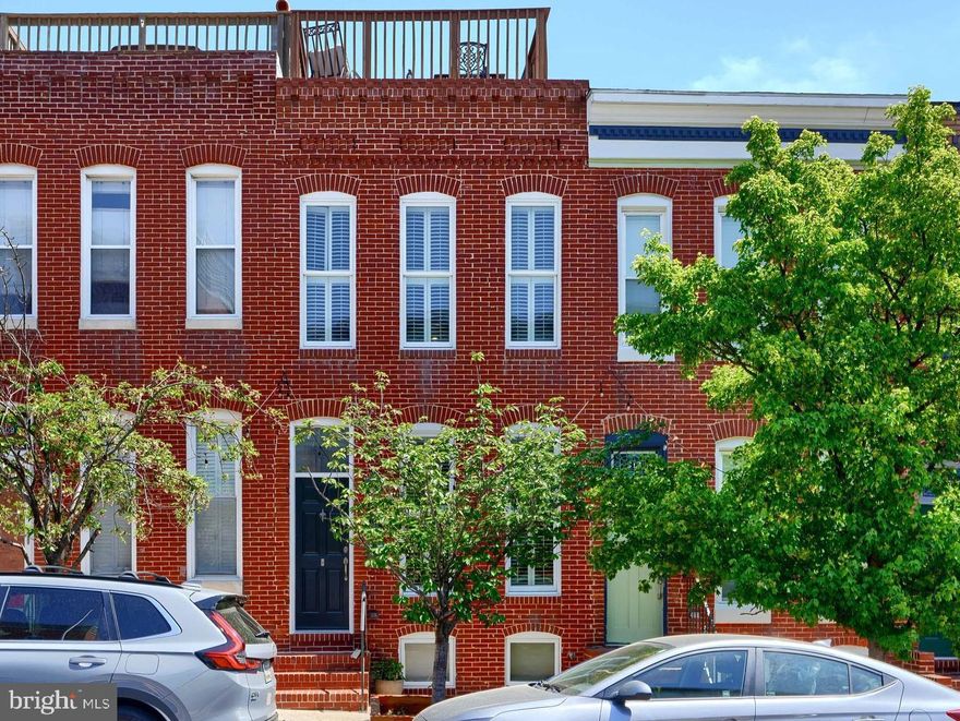 Stunning Canton Property with PARKING PAD & Roof Deck with amazing views!! Located on one of Canton's most desirable blocks, this charming home offers 2,000 +/- of awesome finished living space with modern amenities & a fresh look. Entering the home through the charming vestibule, you'll find a modern kitchen offering granite counters, stainless appliances & room for table with large windows providing tons of natural light.  A convenient half bath and spacious family room are central to the home with a bonus office/desk area in the rear along with access to a parking pad. The upper level offers two generously sized bedrooms with ensuite & large closets. Additional living space can be found in the lower level which is completely finished and can be utilized as a 3rd bedroom/recreation room. Full laundry & a utility closet complete this space. See uploaded Features & Updates for additional information.