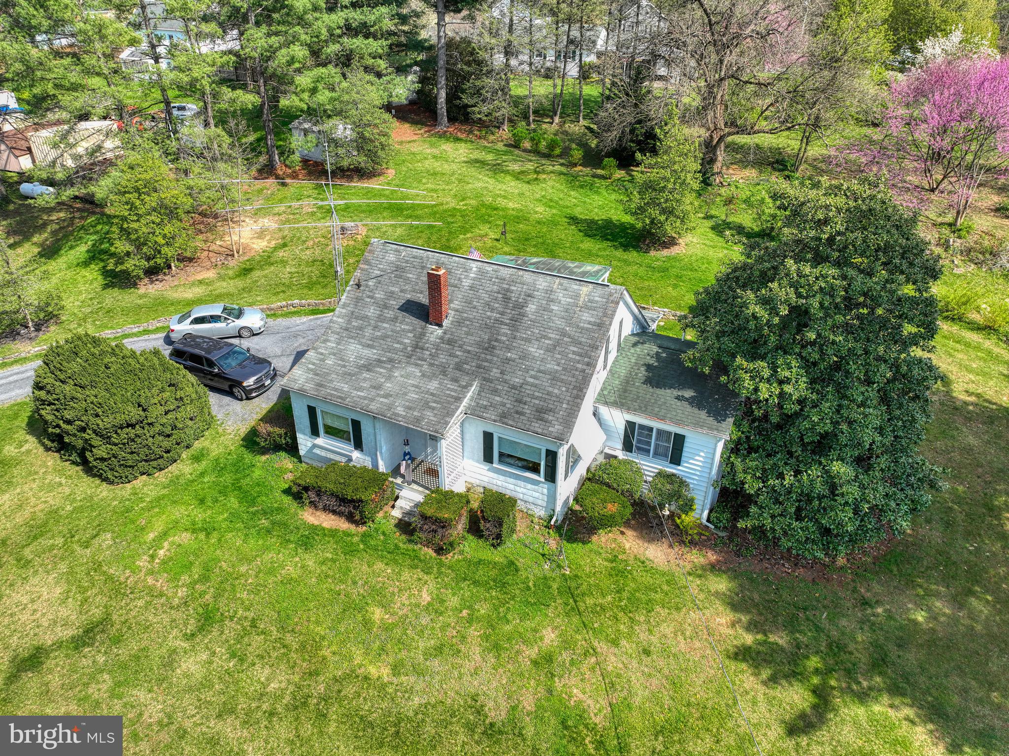 Welcome to this Cape Cod style home, situated on almost an acre of land with mountain views. This home offers 3 bedrooms 2 full baths with hardwood floors and carpet in bedrooms. Enter through the one car carport onto an screened in porch and follow through to a back sunroom where you can enjoy your morning coffee. In the downstairs you have an inviting family room with gas fireplace that will be your gathering place. The propane tank is owned adding extra value and convenience. Also in the downstairs is a dedicated workshop area ideal for DIY projects or storage.
Upstairs in attic area is completely finished with closets.
All appliances convey "as is"