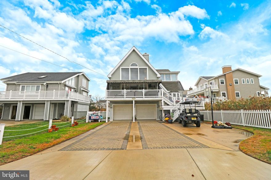 Ready to live in the best neighborhood in Ocean City ? Tucked away right off the 34th street bridge in Merion Park is this unique 4 bedroom 2 full bath beauty. No Condo fees, No parking hassles. This 2 story single will wow all of your senses. High peaked ceilings and ample windows will brighten up every room. Walk up to a large front deck to a foyer to your large dining area ready for your family gatherings. Upper level is the oversized living room with gas fireplace, wall to wall glass doors covered by California shutters opens to a covered porch oasis with TV. Extra large well lit kitchen with an amazing with stone counter space with newer stainless steel appliances and breakfast bar area for your morning coffee. First floor laundry room. Hallway off the kitchen flows to 2 extra large bedrooms with amazing closet space and 1 full bathroom. Second floor stairs has a dramatic view of first levels and walks you right to master bedroom suite with gas fireplace and walk in closet and full bathroom with double sink. Loft area is perfect for overflow guest or reading room. 4th bedroom on second floor with beautiful views of the bay, Are you ready for no shower happy hour? Converted garage on ground level is perfect for a game room complete with a tiki bar, fireplace and TV. Outside shower right off garage area. All windows , siding  and roof replaced in 2012 per prior owner. Well maintained dual Central Air zoned for each floor. This is not a cookie cutter shore home! Be prepared to be amazed.  This home is minutes from beach, marina & fishing pier.   Owner is a licensed realtor