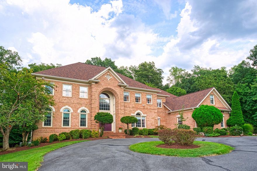 PRICE ADJUSTED- NOW THE LARGEST HOME IN GREAT FALLS UNDER $2M!!! This exceptional estate home, spanning 8970 square feet, offers an unparalleled living experience with its 7 bedrooms, 6 bathrooms, and exquisite full brick exterior. The property's impressive features include a 3 car garage, circular driveway, and a picturesque 1.85 acre corner lot surrounded by mature trees. Upon entering, guests are welcomed by a marble floored grand foyer with a working fountain and staircase, complemented by an additional staircase off the kitchen leading also to the second level. The main level boasts an array of luxurious amenities, including an enclosed sunroom, 2 story family room with a bricked to ceiling fireplace, bar, sunken dining and living rooms, main level bedroom with private exterior access, full bath, marble floored powder room, and separate laundry room with wet sink, storage closet and garage access. The gourmet kitchen is a culinary dream, featuring large dining space, island, top-of-the-line stainless steel appliances, walk-in pantry and ample cabinet space. The second level is a serene retreat, with a spacious primary bedroom boasting a tray ceiling, enormous walk-in closet, and primary bathroom with separate sinks, jacuzzi sunken bathtub, private water closet, and enclosed deep shower space. The walkout lower level is an entertainer's paradise, offering billiards space, bar, a second kitchen (refrigerator, stove/oven, sink and cabinet/counter space), dance floor, and bedroom with full bath. The expansive acreage provides endless opportunities for outdoor entertainment and recreation, making this estate home a true gem. The house has been exceptionally maintained with a multitude of updates/upgrades. The downstairs HVAC was manufactured in May 2013 and the upstairs HVAC was installed in September 2023. The roof was replaced in August 2019. New oversize gutters were installed in July 2019. The driveway was paved in June 2017. The windows in the living room and the room above it were replaced in June 2018. The patio was installed in December 2000. Close to Fairfax County Pkwy, Reston Pkwy, and Route 7- commuting is a breeze. Don't wait in scheduling a visit today!