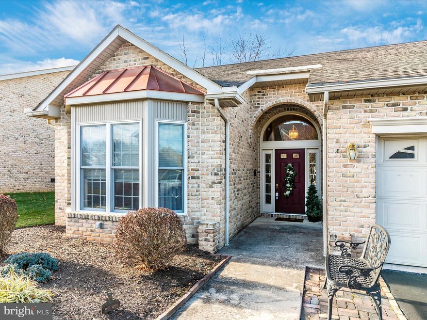 One level living at its finest. Located in the sought after community of Spring Mills Commons, this brick Villa has such charm and curb appeal. End unit with brick exterior and back deck with beautiful views. Front walk way is vaulted with vaulted/open foyer.  Split bedroom plan, each with their own bath and Master with walk-in closet. Ceiling fans throughout.  Formal living and dining with hardwoods, eat-in kitchen with granite countertops, all appliances and garbage disposal. Located off of the eat in kitchen there is a family room with a gas fireplace. Hot water heater and refrigerator are 1 year old,  HVAC was replaced approx. 10 year ago and the roof is being replaced prior to closing.  HOA provides tennis courts, playground area and community pool.