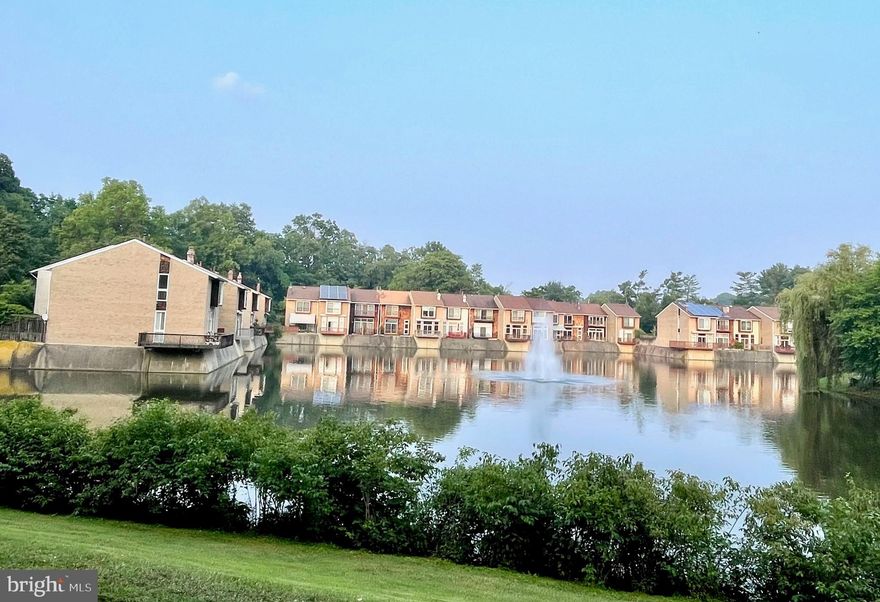VACATION AT HOME IN THIS BEAUTIFULLY  UPDATED 3 BR, 2.5 Bath Townhouse backing to the  New Mark Commons Lake with Stunning WATER VIEWS!  Freshly painted throughout with hardwood floors on the main level and NEW carpet on the upper level, all in market-ready,  cream puff condition!  
KITCHEN RENOVATION completed in 2019 with Gorgeous Italian Marble  Accent Wall,  Natural Cherry Cabinets, Granite countertops, Maytag Stainless Steel Appliances, ceramic backsplash, and an additional Peninsula with extra Cabinets and bar area. Dining Room  features built-in Cabinets with Granite Countertops and Living Room includes an entire wall of built-in shelving,  flat screen TV & sound bar and sliding glass door access to  Patio with remote controlled Awning . UPPER LEVEL  features 3 BR's with  NEW CARPET,  Owner's Suite with En-Suite Shower Bath, ceiling fan and Balcony with Water View!  LOWER LEVEL  includes a Recreation Room or Office with extensive built-in shelving, Utility Room,  Laundry Area with Maytag Washer/Gas Dryer,  laundry sink and storage alcove.  GAS Cooking, Furnace, Hot Water, Dryer and Central Air Conditioning.   Very Convenient location less than a mile to Rockville Town Center, Metro and I-270.  Terrific Community with Pool, Tennis, Tot Lots and adjacent to The City of Rockville's  Dogwood Park with baseball fields and basketball/volleyball/ tennis courts.