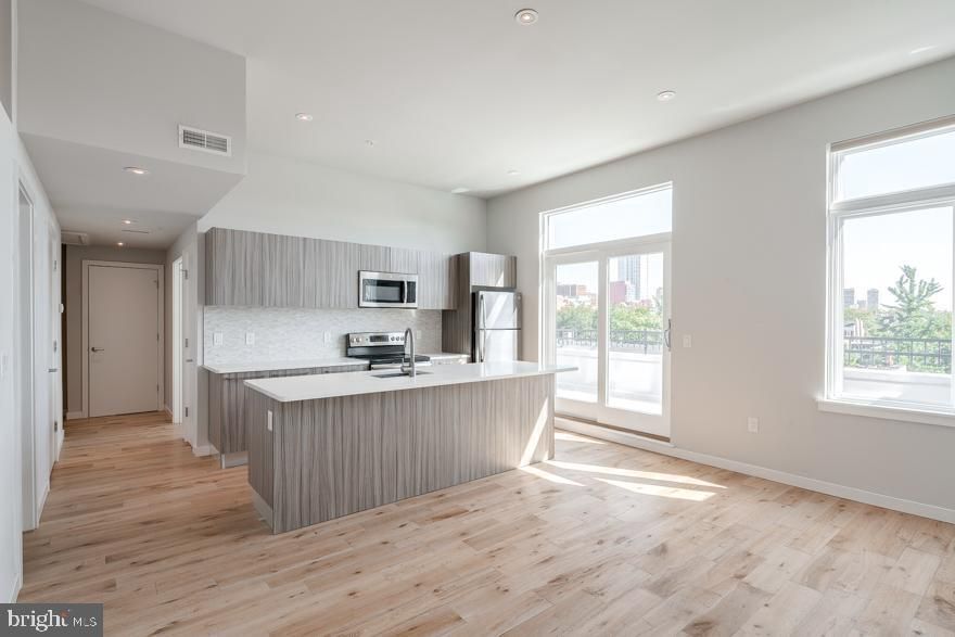 *Available 7/5!*

One of the few 2 bedroom, 2 bathroom units available in Keppoch House! The unit is complete with keyless entry, Nest thermostat, central air, washer/dryer in unit, hardwood floors throughout and recessed lighting. The living room and kitchen is an open concept floor plan that is flooded with natural light from the over-sized windows, high ceilings and sliding glass doors that lead to a private deck! The kitchen includes quartz counter top and island counter top, brand new modern cabinetry, designer lighting, and stainless steel dishwasher, microwave, refrigerator and electric stove/oven. The first bedroom is spacious and includes lofted windows that provide diffused lighting from the living room, a ceiling fan, a walk-in closet and en-suite bathroom. The second bedroom also features a large window with a view of the deck, a large closet and ceiling fan.

Keppoch House: Situated on the tree-line 13th Street corridor that includes a bike lane connecting the Bella Vista and Washington Square neighborhoods and parallel to the Avenue of the Arts. You’ll be within walking distance in every direction of the City’s best bars, restaurants, boutiques, culture, performance and visual arts. The amenities in the building include an elevator, free gym access, a shared roof deck and limited parking availability.

Lease Terms: Generally, 1st month, and 1 month security deposit due at, or prior to, lease signing. Other terms may be required by Landlord such as last month’s rent upfront. $65 application fee per applicant. Tenants are responsible for: electricity, gas (if applicable), cable/internet and $10/mo technology fee. Water is a flat monthly fee of $60. Additional fees or requirements may be applicable for units with Homeowners or Condo Associations. Landlord Requirements: Applicants to make 3x the monthly rent in verifiable gross income, credit history to be considered, no evictions within the past 5 years, and must have a verifiable rental history with on-time rental payments. Exceptions to this criteria

*Pets permitted with owner permission; $350 non-refundable pet fee plus $35/month pet rent
*Photos are of a similar unit in the building, finishes will match, exact layout may differ slightly