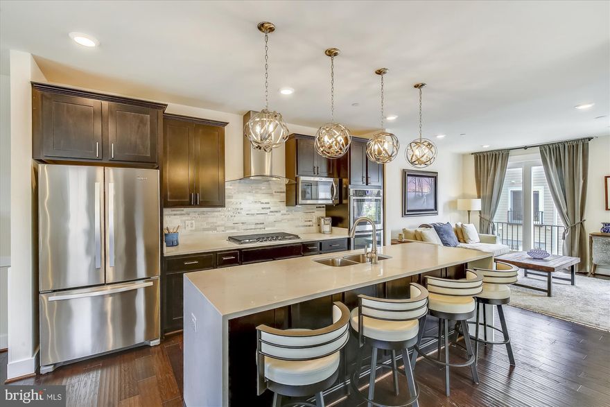 Absolutely stunning end-unit townhouse built in 2017 and walking distance to upcoming Potomac Yard metro and Old Town. Main entry level includes a fenced front yard, 2-car garage with electric car charging station, bedroom and full bath. Next level is gorgeous gourmet kitchen with quartz counters, stainless appliances, double oven, and bar stools that convey. Open concept dining and living areas. A half bath is nestled on the landing for privacy. Bedroom level features a master suite and third bedroom with its own full bath. Retreat to the upper level loft for quiet time or step out onto the roof deck to enjoy the night sky. Loft level features an additional half bath for convenience. Custom cordless honeycomb, top down/bottom up blinds. Guest room includes black out blinds. Custom drapes throughout convey, including living room level velvet and Belgium linen. Next doorbell and heating system. Samsung washer & dryer; latest model - double washer and dryer. Parkland and trails behind community are easy to access. Walk to restaurants and shops like Rustico, Tropical Smoothie Cafe, Buzz Bakeshop, Vaso's Kitchen, Slater's Market, Poppy Nails & Spa, and more. So convenient to Metro, Airport, Beltway, GW Parkway.