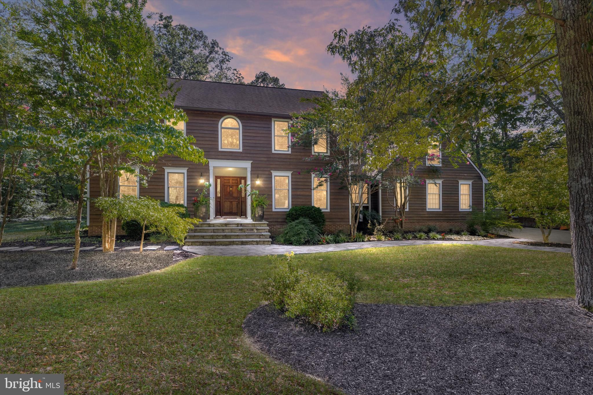 Welcome to 3471 Monitor Court — a beautifully renovated home tucked away on a private wooded cul-de-sac in Davidsonville’s premier waterfront community of Harbor Hills. Move-in ready and thoughtfully designed for both everyday living and entertaining, the main level showcases gleaming hardwood floors throughout. The stunning designer kitchen (2022) is outfitted with premium appliances, including a Fisher & Paykel induction freestanding range, Bosch refrigerator-freezer, XO undercounter beverage cooler, and Monogram built-in dishwasher and drawer microwave. Seamlessly connected to the kitchen, the spacious great room features a cozy fireplace and bay window, while a private office, formal dining room, and a living room with a second fireplace complete the main floor. Upstairs, the expansive primary suite offers a sunny bump-out with garden views and a renovated spa bath. Just outside the suite, a private library/office with its own fireplace provides a quiet retreat. Three additional bedrooms and a beautifully updated full bath surround the open staircase of the two-story foyer, creating a light-filled and inviting layout. The lower level offers a generous living area with fireplace and a stylish shiplap-wrapped bar, perfect for movie nights or game-day gatherings. A newly added screened porch, Trex deck, and firepit extend the living space outdoors, making it easy to enjoy every season. Living in Harbor Hills means more than owning a home—it’s embracing a lifestyle. The community offers a pool, clubhouse, marina with boat slips, two sandy beaches, pickleball and tennis courts, ball fields, and a vibrant calendar of social events. From a short walk to the water to evenings gathered around the firepit, this property seamlessly blends the ease of modern living with the benefits of a premier waterfront community.