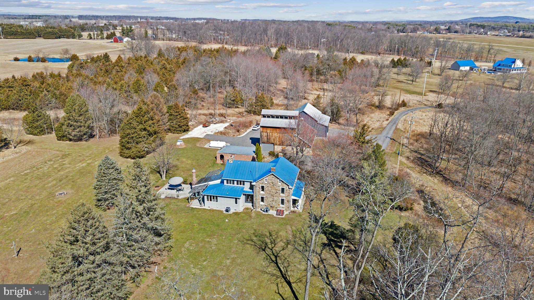 Situated on just over Twenty Six acres, this updated stone home blends classic charm with modern amenities. The spacious home features Four bedrooms and Three baths, including a main-floor primary suite for ultimate convenience. A custom kitchen with high-end finishes flows into a stunning atrium, creating a bright and inviting atmosphere. Beyond the home, the property boasts a Forty eight hundred sq. ft. shop, with over Eighteen hundred sq. ft. of fully finished space, perfect for business, hobbies, or storage. A 20x24 tractor shed adds even more versatility. With mixed-use zoning, this property offers endless possibilities, whether for residential, commercial, or agricultural use. Enjoy the beauty of country living with the space and flexibility to make it your own!