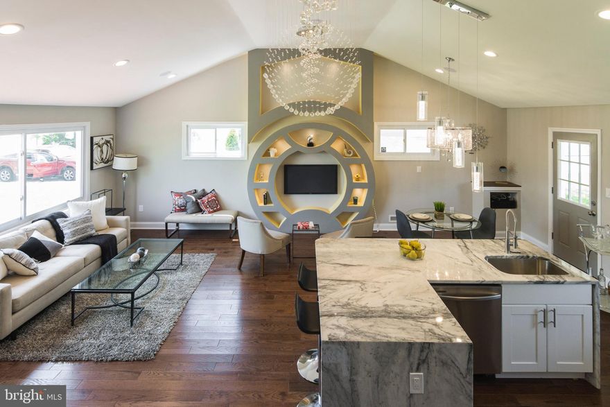 Welcome to "New Northwood" This rare exceptionally redesigned split level home is located steps from Morgan State University and Towson. Walk in to the well lit open floorplan, with stunning chandeliers, recessed lighting, Bluetooth Home Theater Surround sound throughout, and a custom crafted feature wall.  The gourmet kitchen is designed with the chef of the house in mind with all new cabinets, countertops and stainless steel appliances. Off of the dining room walk onto the patio that looks out in to a huge yard with a large parking pad that could fit 4 or more cars. The French doors lead to the lower level that has a full bedroom, a family room or additional bedroom and Jack and Jill full bath. The Upper level has  2 Master Suites  the main one has  a custom bath and a walk out to the huge deck, that overlooks the yard. Bring your buyer, and let's get this SOLD!